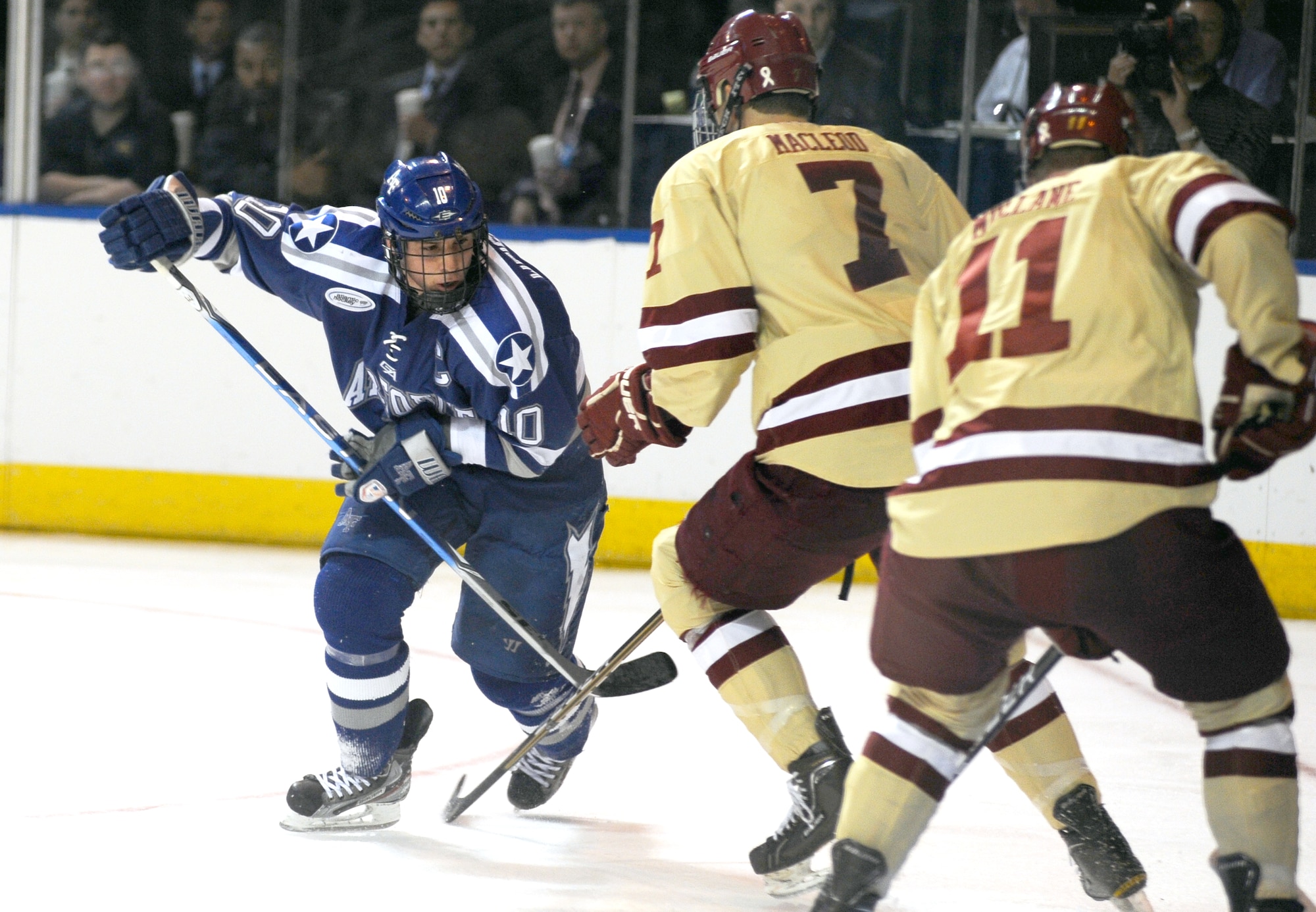 Paul Weisgarber tries to push past two Boston College Eagles during the NCAA Hockey Championship Tournament in Worcester, Mass., March 24, 2012. The Air Force Academy Falcons came up short against the Eagles 2-0. Weisgarber is the Falcons’ team captain. (U.S. Air Force photo/Tech. Sgt. Raymond Hoy)