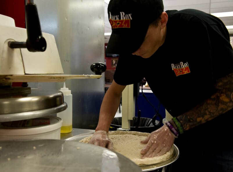 Devon Denomie, kitchen crew, forms pizza dough March 26, 2012, prior to the grand opening of Black Box Pizza at Dyess Air Force Base, Texas. Black Box Pizza is available by delivery to on-base residents as well as service members in Quail Hallow. For more information, call (325) 696-5555. (U.S. Air Force photo by Airman 1st Class Jonathan Stefanko/ Released)