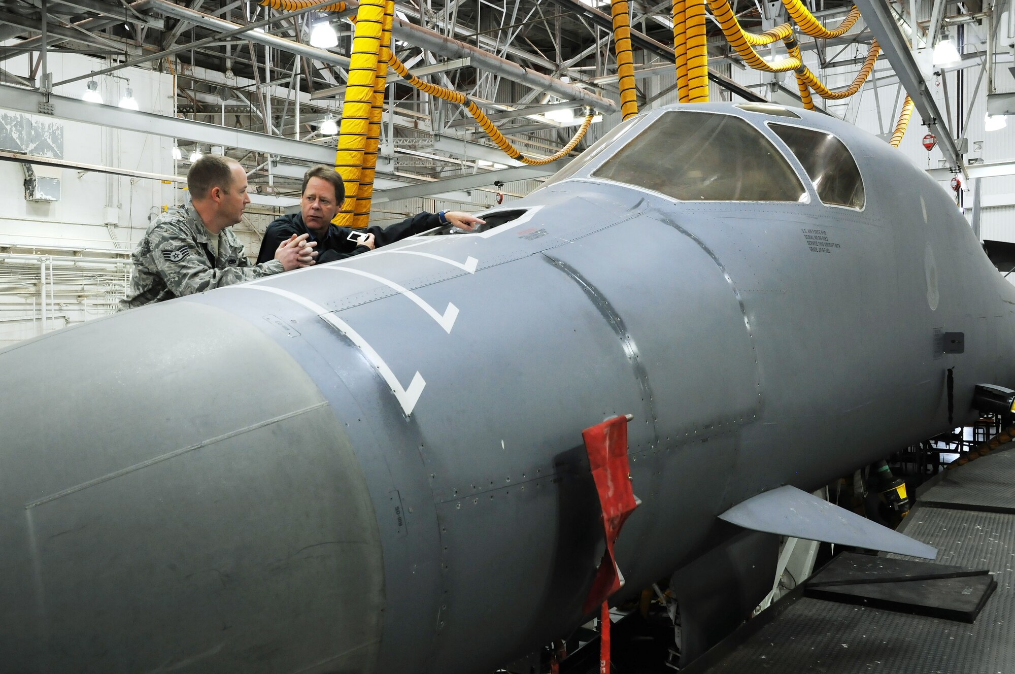 Dyess Air Force Base, Texas -- Staff Sgt. Mike Glackmeyer, 7th Equipment Maintenance Squadron, shares his knowledge of the B-1 Lancer with John Schueler, president of Florida Communications Group, during a tour of the aircraft at Dyess Air Force Base, Texas, March 20, 2012.  Schueler is a visiting honorary commander from Macdill AFB in Tampa, Florida.  (U.S. Air Force photo by Staff Sgt. Jennie Chamberlin)