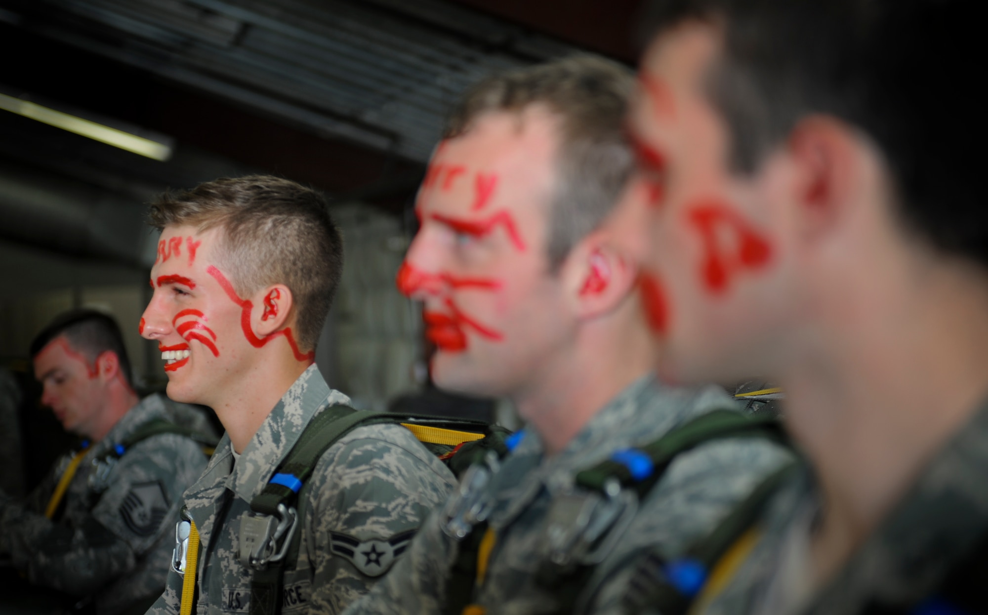 U.S. Air Force Airman 1st Class Fedor Potanin, 823d Base Defense Squadron fireteam member, laughs as he stands beside other first-time jumpers at Moody Air Force Base, Ga., March 21, 2012. First-time jumpers of the 820th Base Defense Group receive face paint to signify their first jump after completing the U.S. Army Basic Airborne Course. (U.S. Air Force photo by Airman 1st Class Douglas Ellis/Released)
