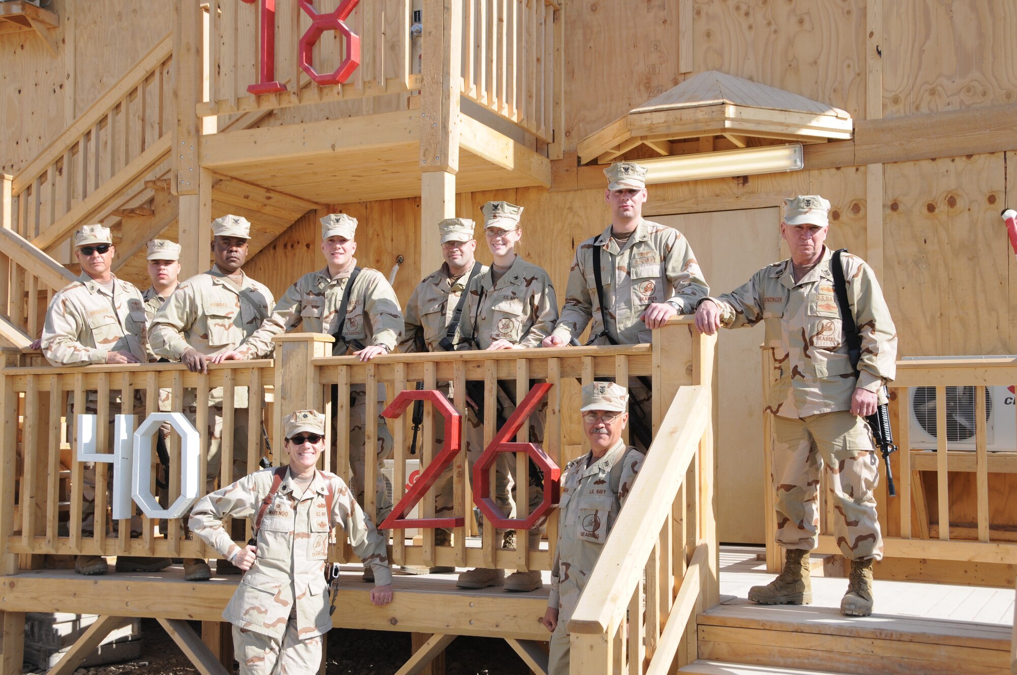 Commander Regina Marengo, lower left, stands with some of the Sailors from Naval Mobile Construction Battalion 26 at a work site in Afghanistan, where the battalion spent the last half of 2010 and the first half of 2011. Both the battalion and the commander were each recently honored as being among the best in the Navy. NMCB-26 is based at Selfridge Air National Guard Base, Mich., and has detachments in 10 locations across Michigan, Ohio and Indiana. About 700 Navy Reserve Seabees serve in the battalion. (U.S. Navy photo)