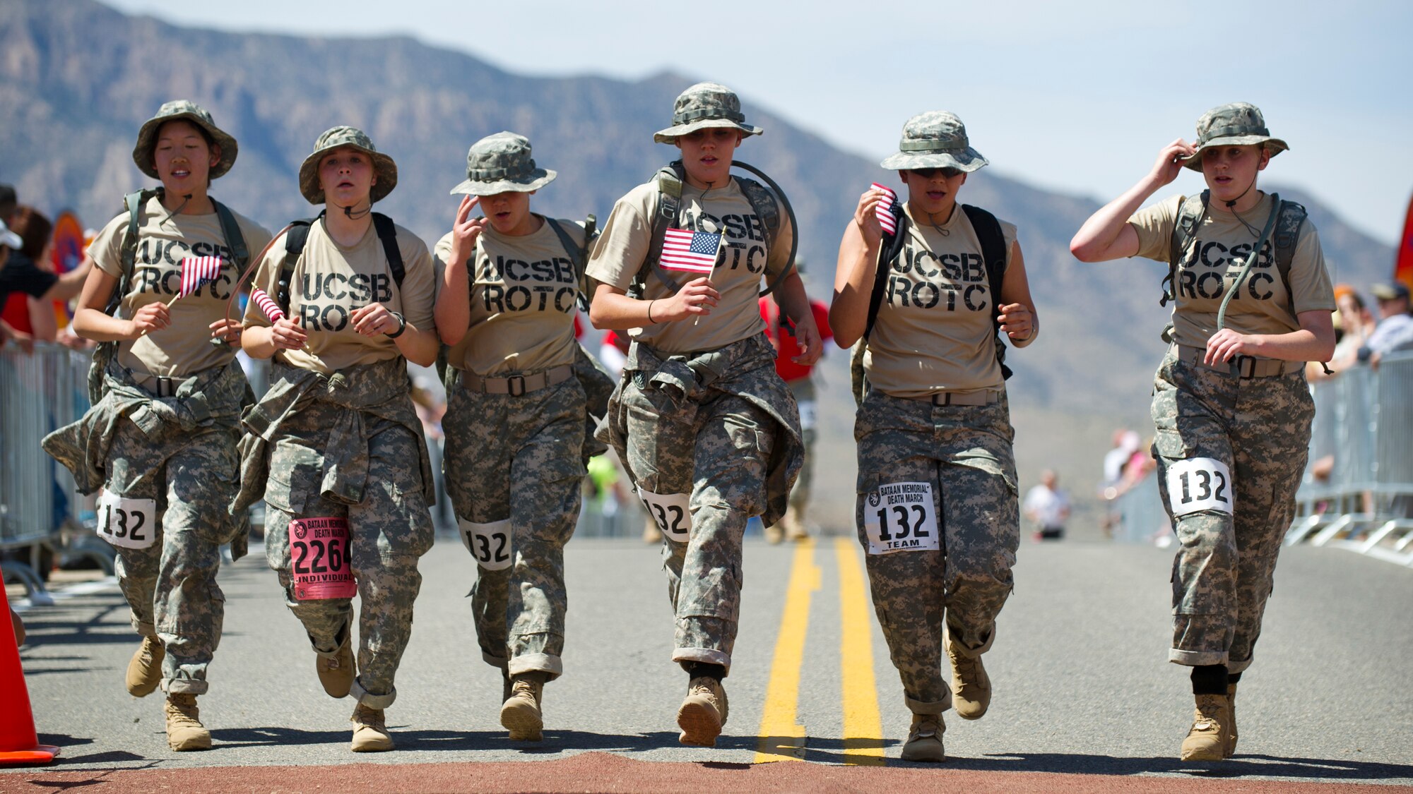 WHITE SANDS MISSILE RANGE, N.M. – University of California Santa Barbara U.S. Army Reserve Officers' Training Corps members cross the finish line of the Bataan Memorial Death March as a team here March 25.  Brandon Peer, 27, of Fort Collins, Colo., was the first ROTC participant to finish the marathon in the ROTC - heavy category, with a chip time of 5:58:28; Alexander Babos, 19, of Fort Collins, Colo., was the first in the ROTC - light category, with a chip time of 3:53:44. (U.S. Air Force photo by Airman 1st Class Daniel E. Liddicoet/Released)