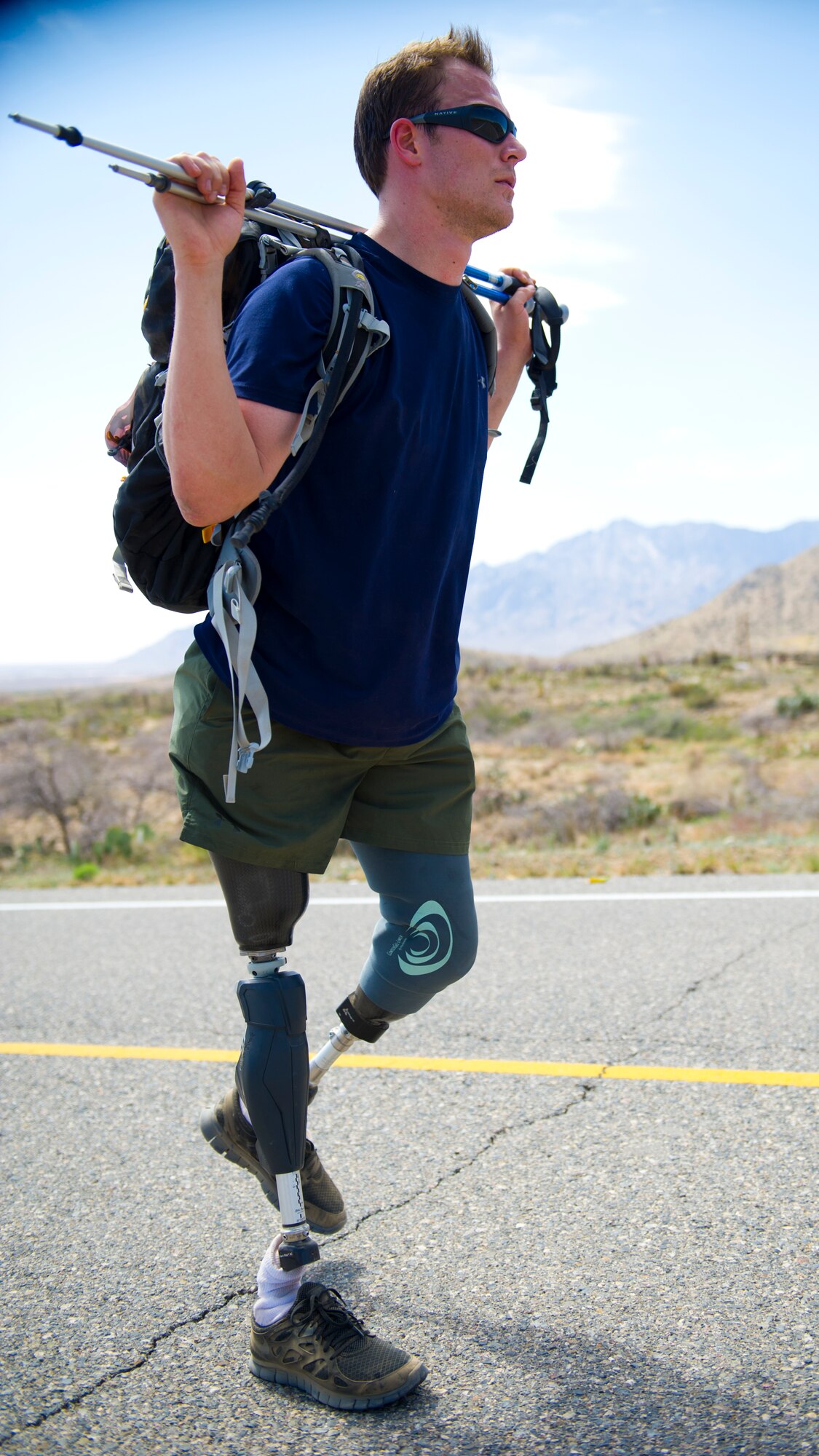 WHITE SANDS MISSILE RANGE, N.M. – A double-amputee and wounded warrior participant in the Bataan Memorial Death March continues along the course here March 25. Several wounded warriors who were missing one or more limbs completed the full marathon in honor of those who endured the 80-mile Bataan Death March in 1942. (U.S. Air Force photo by Airman 1st Class Daniel E. Liddicoet/Released)