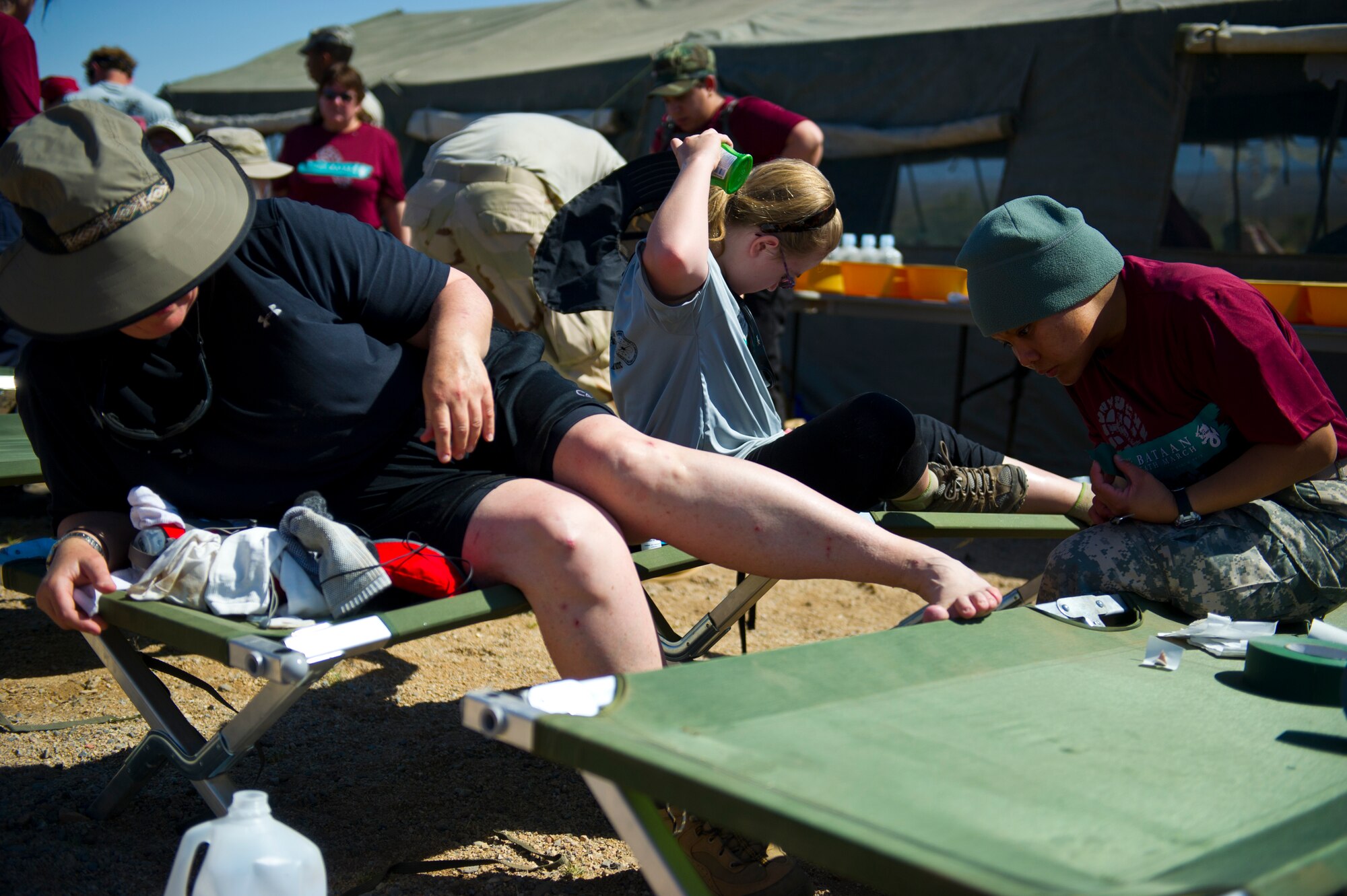 WHITE SANDS MISSILE RANGE, N.M. – Sherri Rowe, a participant in the Bataan Memorial Death March, receives medical treatment for blisters at a rest stop along the course here March 25. Many participants suffered minor injuries, such as blisters and cramps, along the course. Volunteer medics were on hand to assist at all times. (U.S. Air Force photo by Airman 1st Class Daniel E. Liddicoet/Released)