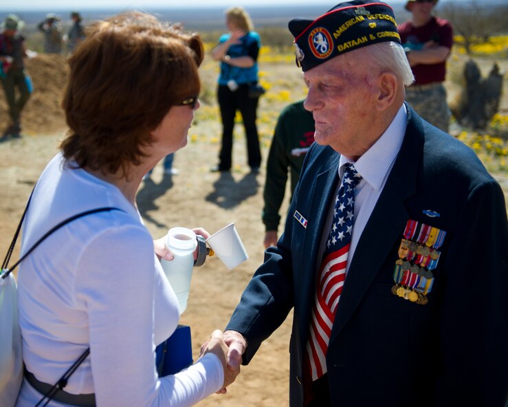 WHITE SANDS MISSILE RANGE, N.M. – William Eldridge, a former machine gunner with the U.S. Army 31st Infantry Regiment and survivor of the Bataan Death March, shakes the hand of a participant near the halfway point of the Bataan Memorial Death March here March 25. Participants had the opportunity to shake the hands of 16 attending survivors of the Bataan Death March near the halfway point and at the finish line of the course. (U.S. Air Force photo by Airman 1st Class Daniel E. Liddicoet/Released)