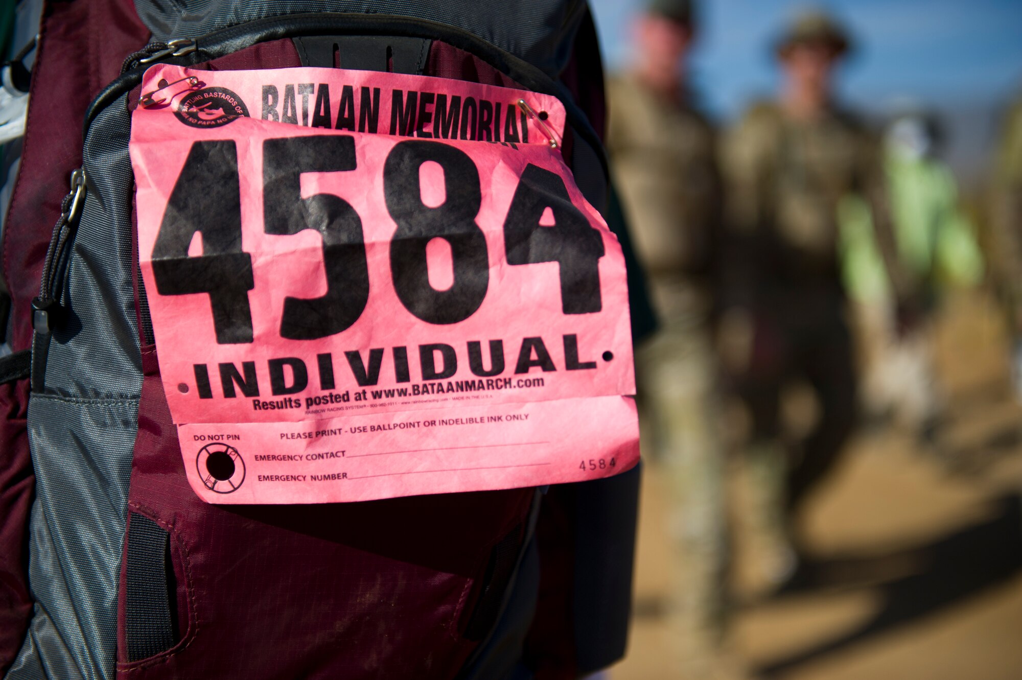 WHITE SANDS MISSILE RANGE, N.M. – A participant displays an individual race number on her backpack during the Bataan Memorial Death March here March 25. The march began around 7 a.m., and the course stayed open until 8 p.m., when darkness fell and it was no longer safe for participants to continue.  (U.S. Air Force photo by Airman 1st Class Daniel E. Liddicoet/Released)