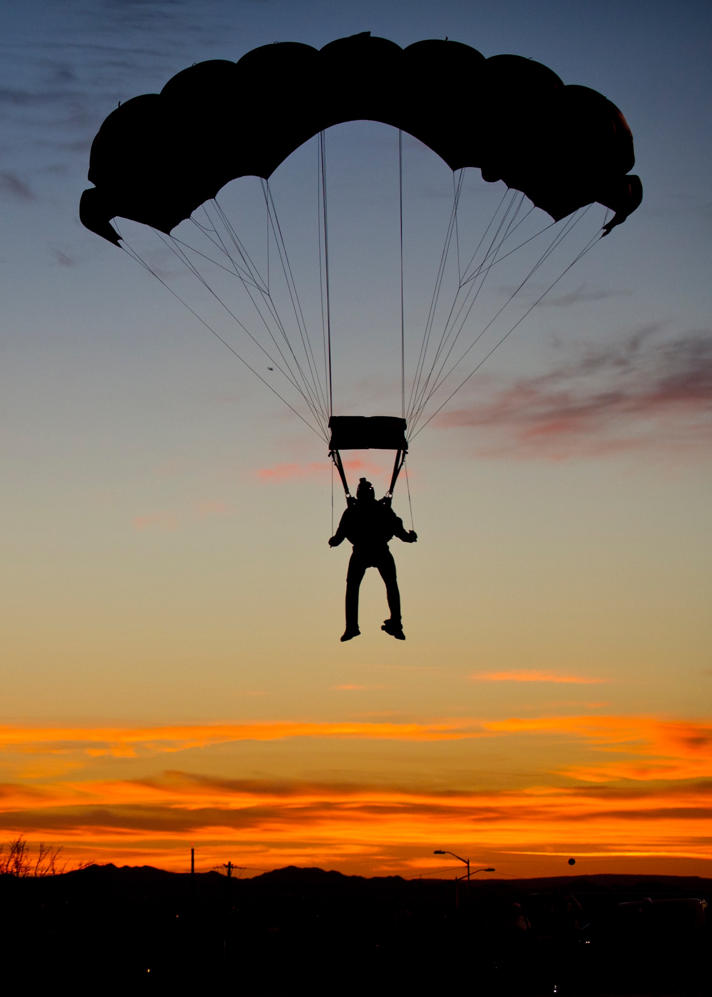WHITE SANDS MISSILE RANGE, N.M. – A member of the Black Daggers, a U.S. Army Special Operations Command parachute demonstration team, prepares to land during the opening ceremony of the Bataan Memorial Death March here March 25. The demonstration team is comprised of volunteers from throughout ARSOC, all with diverse backgrounds. They are skilled in various military specialties, including Special Forces, Rangers, civil affairs, psychological operations, and signal and support. This was the first year the Black Daggers participated in the opening ceremony of the Bataan Memorial Death March. (U.S. Air Force photo by Airman 1st Class Daniel E. Liddicoet/Released)