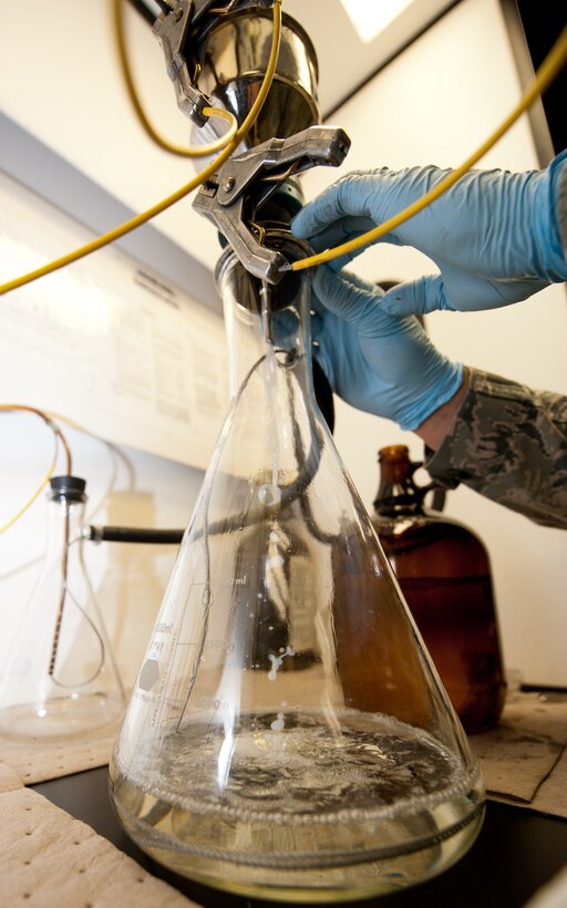 Airman 1st Class Collin Dunn, 28th Logistic Readiness Squadron fuels laboratory technician, seals a bottle method during an aircraft fuel test in the Fuels Lab at Ellsworth Air Force Base, S.D., March 22, 2012. The seal ensures nothing enters the bottle, filters, or fuel during the test, for accurate results. (U.S. Air Force photo by Airman 1st Class Kate Thornton/Released) 