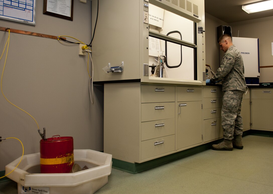 Airman 1st Class Collin Dunn, 28th Logistic Readiness Squadron fuels laboratory technician, prepares to conduct a bottle method test on aircraft fuel in the Fuels Lab at Ellsworth Air Force Base, S.D., March 22, 2012. The test measures levels of water, additives, sediment and particulates in fuel to ensure the fuel is within the required limits. (U.S. Air Force photo by Airman 1st Class Kate Thornton/Released)