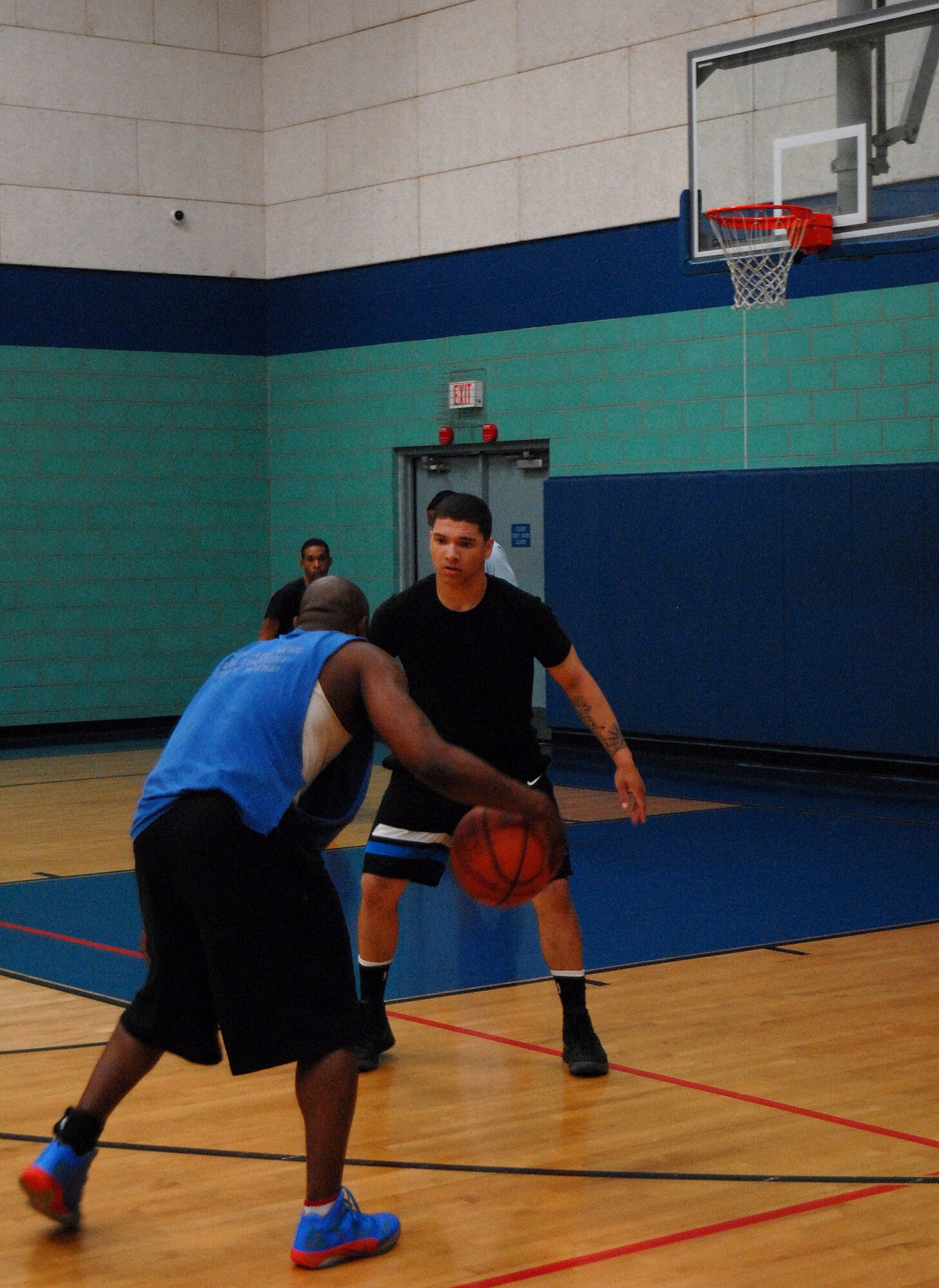 GOODFELLOW AIR FORCE BASE, Texas-- Staff Sgt. Sharad White, 17th Communications Squadron, prepares to go up against a defender while playing in the March Madness 3-on-3 Basketball Tournament, March 24, here. The single elimination tournament consisted of 15 participating teams competing to be the champions.  (U.S. Air Force photo/Airman 1st Class Michael Smith)