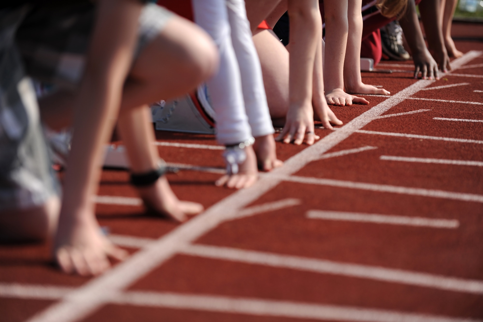 BITBURG ANNEX, Germany – Spangdahlem and Bitburg Elementary School students get ready for the 100-meter dash during a track and field day at the Bitburg High School track here March 24. The BHS track team hosted the event to introduce the first- through sixth-grade students to the sport’s events. The team taught students about track and field to promote interest in staying active and healthy. (U.S. Air Force photo by Airman 1st Class Matthew B. Fredericks/Released)