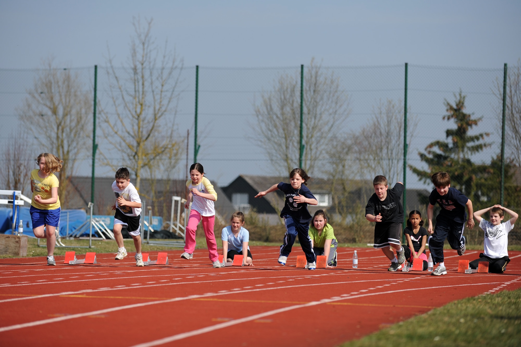 BITBURG ANNEX, Germany – Spangdahlem and Bitburg Elementary School students begin the 100-meter dash during a track and field day at Bitburg High School track here March 24. The BHS track team hosted the event to introduce the first- through sixth-grade students to the sport’s events. The team taught students about track and field to promote interest in staying active and healthy. (U.S. Air Force photo by Airman 1st Class Matthew B. Fredericks/Released)