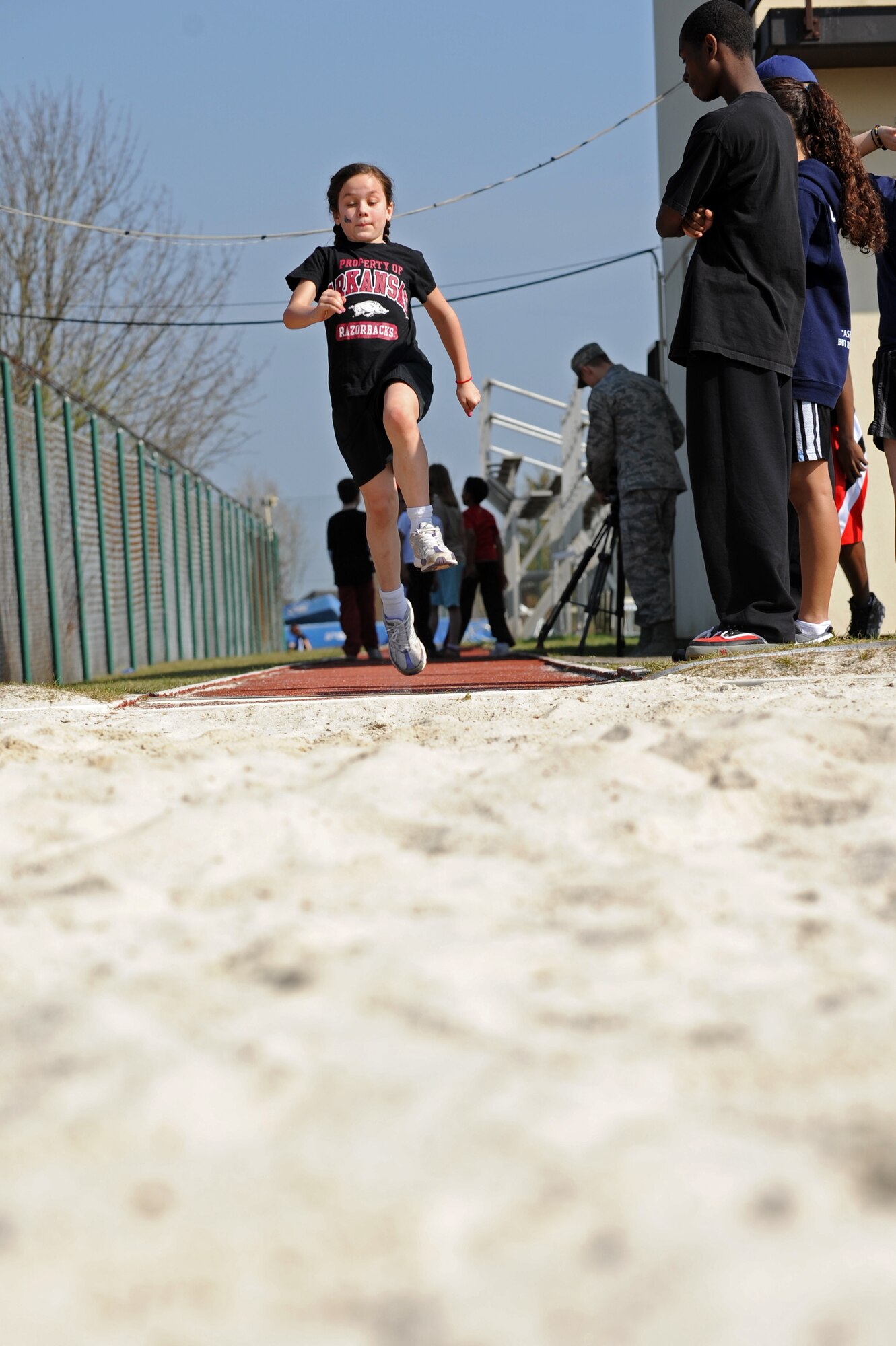 BITBURG ANNEX, Germany – Isabella Naglack, daughter of Master Sgt. Mark Naglack, 52nd Equipment Maintenance Squadron, long jumps during a track and field day at the Bitburg High School track here March 24. The BHS track team hosted the event to introduce first- through sixth-grade students from the Spangdahlem and Bitburg Elementary and Middle Schools to the sport’s events. The team taught students about track and field to promote interest in staying active and healthy. (U.S. Air Force photo by Airman 1st Class Matthew B. Fredericks/Released)
