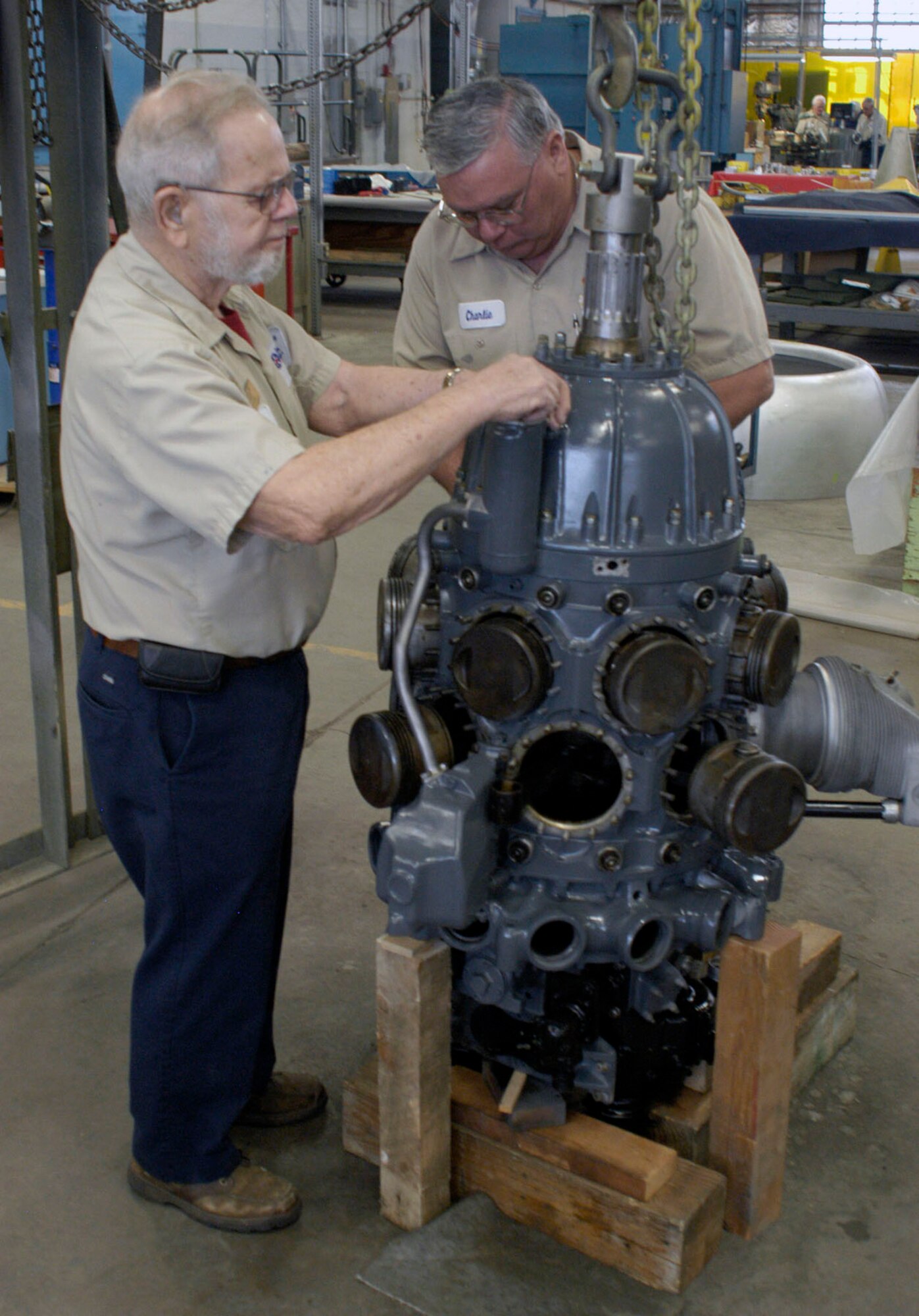 DAYTON, Ohio (03/2012) -- Charlie Leist (left) and Charlie Farlow are two of the volunteers working on the R-1535-7 engine. (U.S. Air Force photo)