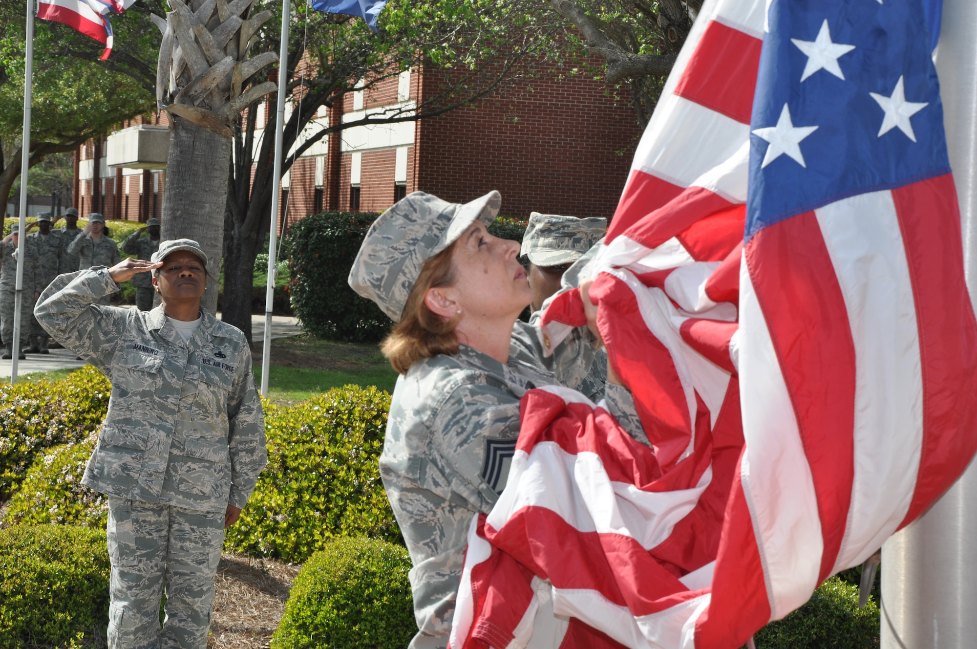 Women from Joint Base Charleston fold the flag during an all female retreat ceremony on March 23 to celebrate Women’s History Month. About forty women from the 628th Air Base Wing, the 437th and 315th Airlift Wings took part in the ceremony. (U.S. Air Force photo/Michael Dukes)
