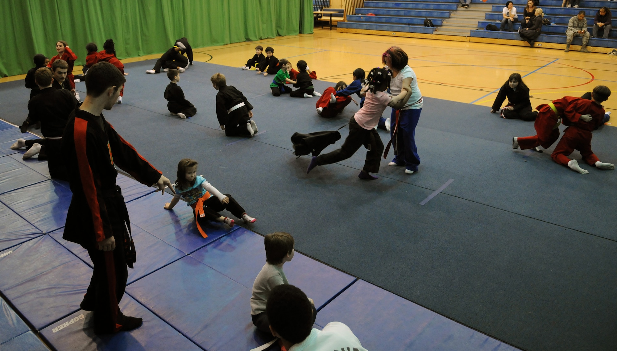 RAF MILDENHALL, England -- Students in the RAF Mildenhall Youth Center’s Karate Camp perform free-sparring exercises March 15, 2012. Practicing martial arts styles taekwondo and hapkido, the monthly camp allows students to conduct larger exercises than their standard weekly classes afford. (U.S. Air Force photo/Staff Sgt. Thomas Trower)