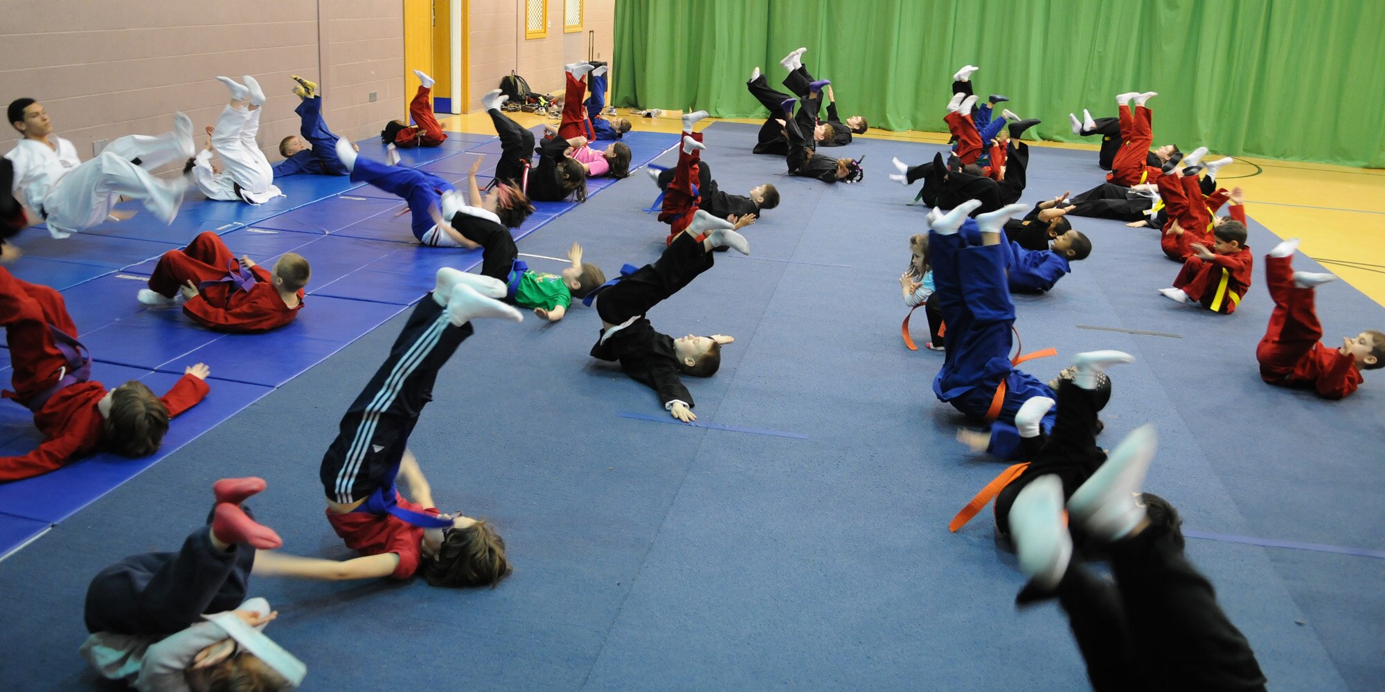 RAF MILDENHALL, England -- Students in the RAF Mildenhall Youth Center’s Karate Camp practice fall techniques March 15, 2012. Rehearsing ways to fall correctly can help prevent injuries during other martial arts exercises. (U.S. Air Force photo/Staff Sgt. Thomas Trower)