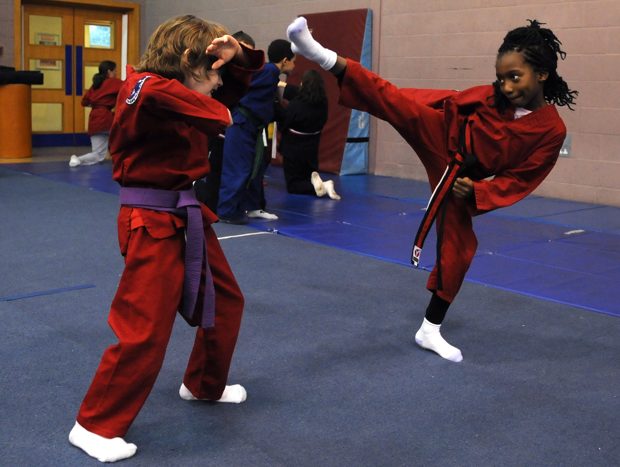 RAF MILDENHALL, England -- Maximus DeMarco blocks a high kick from Ahmira Palmer during the RAF Mildenhall Youth Center’s Karate Camp March 15, 2012. The students learned moves associated with the martial arts styles of taekwondo and hapkido.  (U.S. Air Force photo/Staff Sgt. Thomas Trower)
