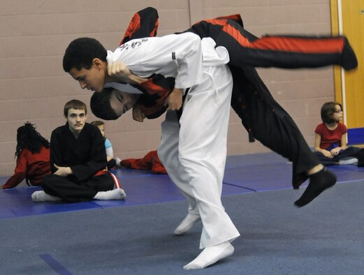 RAF MILDENHALL, England -- Brian Miles flips Daniel McCollum during a martial arts demonstration for students of the RAF Mildenhall Youth Center’s Karate Camp March 15, 2012. Held monthly, the camp provides the youths an opportunity to practice larger exercises than in the center’s normal weekly karate courses. (U.S. Air Force photo/Staff Sgt. Thomas Trower)