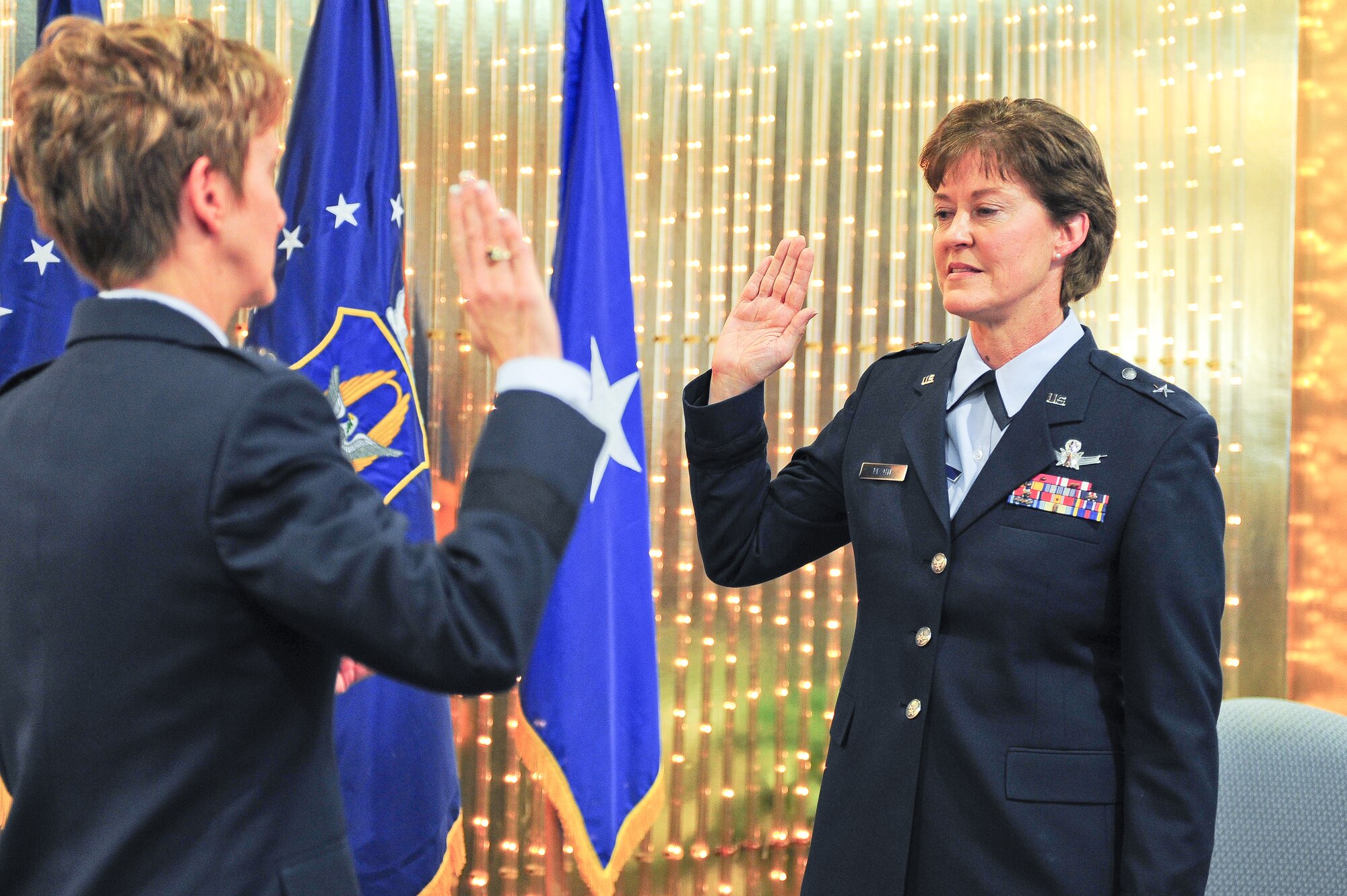 Brig. Gen. Karen A. Rizzuti recites the oath of office at her promotion ceremony officiated by Brig. Gen. Jane C. Rohr, the mobilization assistant to the Commander, 14th Air Force, Vandenberg Air Force Base, Calif., at Peterson Air Force Base, Colo. on Mar. 19. Rizzuti, the former 310th Space Wing commander is the Vice Commander of 10th Air Force, headquartered at Naval Air Station Fort Worth Joint Reserve Base, Texas. Rizzuti's family, friends and former co-workers were also in attendance at the promotion ceremony. (U.S. Air Force photo/Tech. Sgt. Nicholas B. Ontiveros).