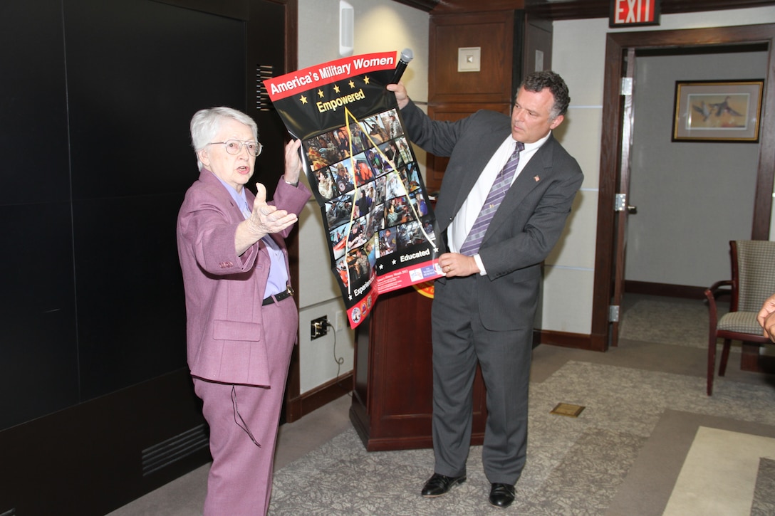WASHINGTON -- Retired U.S. Air Force Brig. Gen. Wilma L. Vaught presents Dale Stoutenburgh, Director of the U.S. Army Corps of Engineers Humphreys Engineer Center Support Activity, a Women's History Month poster after her keynote speech at the USACE headquarters here, Mar. 26, 2012. Vaught has paved the way for women in the military, but her most lasting contribution is her effort and driving force to build the Women in Military Service for America Memorial, located at Arlington National Cemetery, which honors women who have served in the U.S. military.