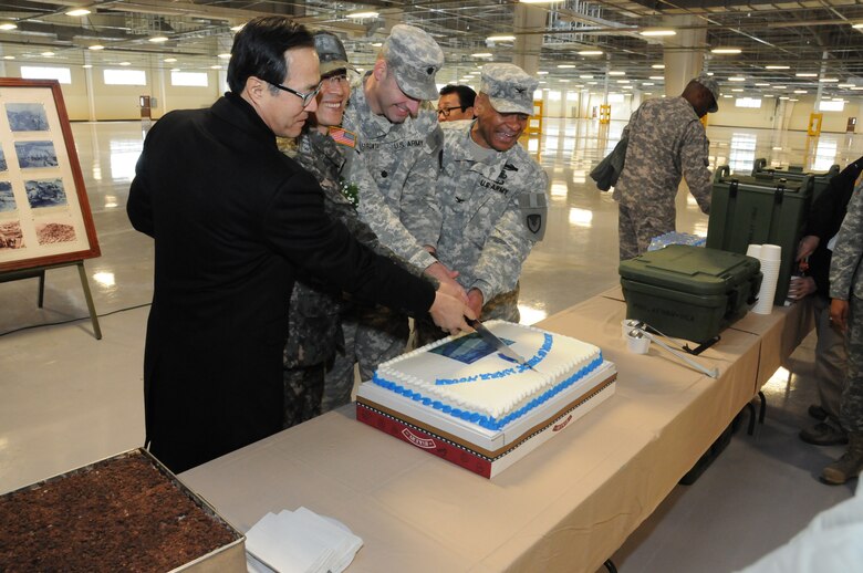 (From left to right) Oh, Sae-ick, President of Ilsung Construction Co., Capt. Ryu Gyu-seok, Chief of U.S. Forces Korea Construction Management Team, Republic of Korea Ministry of National Defense-Defense Installation Agency, Lt. Col. Douglas Pietrowski, U.S. Army Field Support Battalion, Northeast Asia Commander, and Col. Michael Lopez, Army Field Support Brigade Commander cut the cake during the ribbon cutting ceremony for the new humidity controlled warehouse at Camp Carroll Feb. 10.