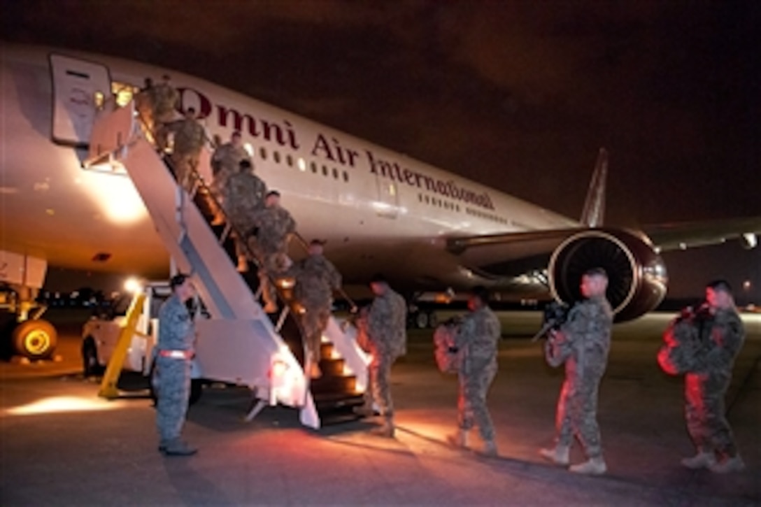 Soldiers board a commercial aircraft on the first leg of a deployment to Afghanistan March 21, 2012, from Pope Army Air Field, Fort Bragg, N.C. The paratroopers will travel on several aircraft, including helicopters, to get to their final destinations on forward operating bases. 