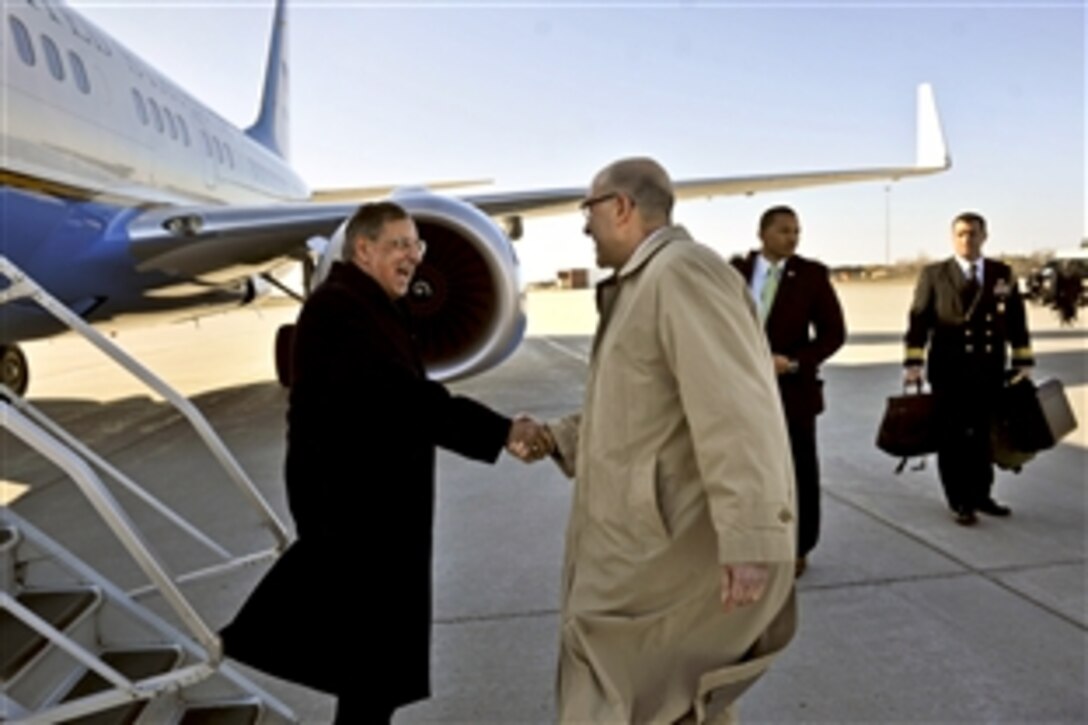 U.S. Defense Secretary Leon E. Panetta, left, shakes hands with U.S. Ambassador to Canada David Jacobson as the secretary arrives in Ottawa, Ontario, March 26, 2012, to attend trilateral meetings with Canadian and Mexican officials.