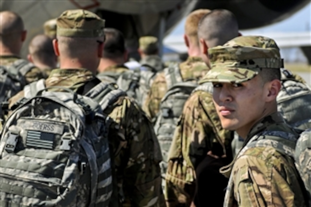Airman 1st Class Jeremy Quesada glances back to family and friends seeing him off at Hancock field in Syracuse N.Y., on March 21, 2012.  Quesada, assigned to the 174th Fighter Wing Security Forces, and 30 other airman from his unit are deploying to Afghanistan for six months.  