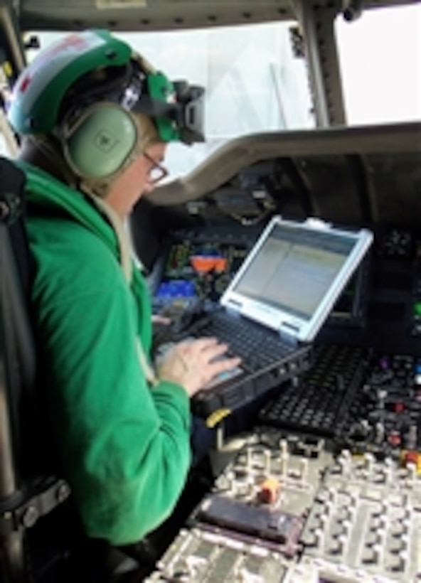 Petty Officer 1st Class Charles Cisneros performs diagnostic checks on the mission systems of an MH-60R Sea Hawk helicopter assigned to Helicopter Maritime Strike Squadron 77 on the flight deck of the aircraft carrier USS Abraham Lincoln (CVN 72) underway in Arabian Sea on March 10, 2012.  The Abraham Lincoln is deployed to the U.S. 5th Fleet area of responsibility conducting maritime security operations, theater security cooperation efforts and support missions as part of Operation Enduring Freedom.  