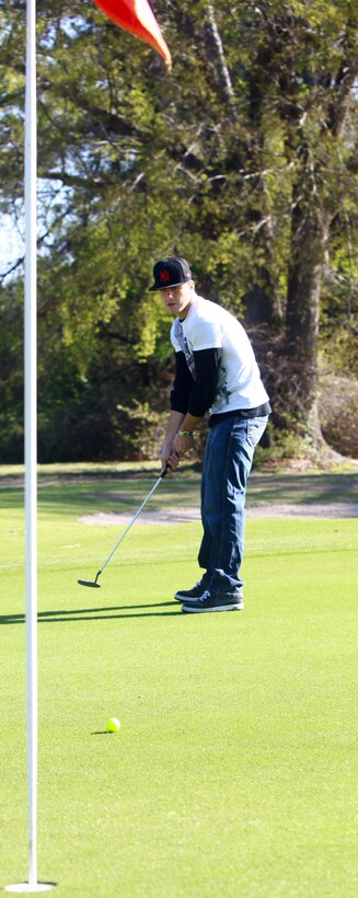 A Marine with Combat Logistics Battalion 8, 2nd Marine Logistics Group attempts a putt during a golf outing at the Paradise Point Golf Course aboard Camp Lejeune, N.C., March 27, 2012. The purpose of the day was to give the battalion’s Marines and sailors a day of rest and relaxation. (U.S. Marine Corps photo by Pfc. Franklin E. Mercado)