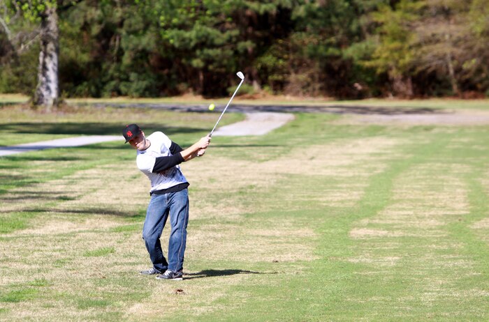 A Marine with Combat Logistics Battalion 8, 2nd Marine Logistics Group hits a golf ball during a golf outing at the Paradise Point Golf Course aboard Camp Lejeune, N.C., March 27, 2012. The purpose of the day was to give the battalion’s Marines and sailors a day of rest and relaxation. (U.S. Marine Corps photo by Pfc. Franklin E. Mercado)