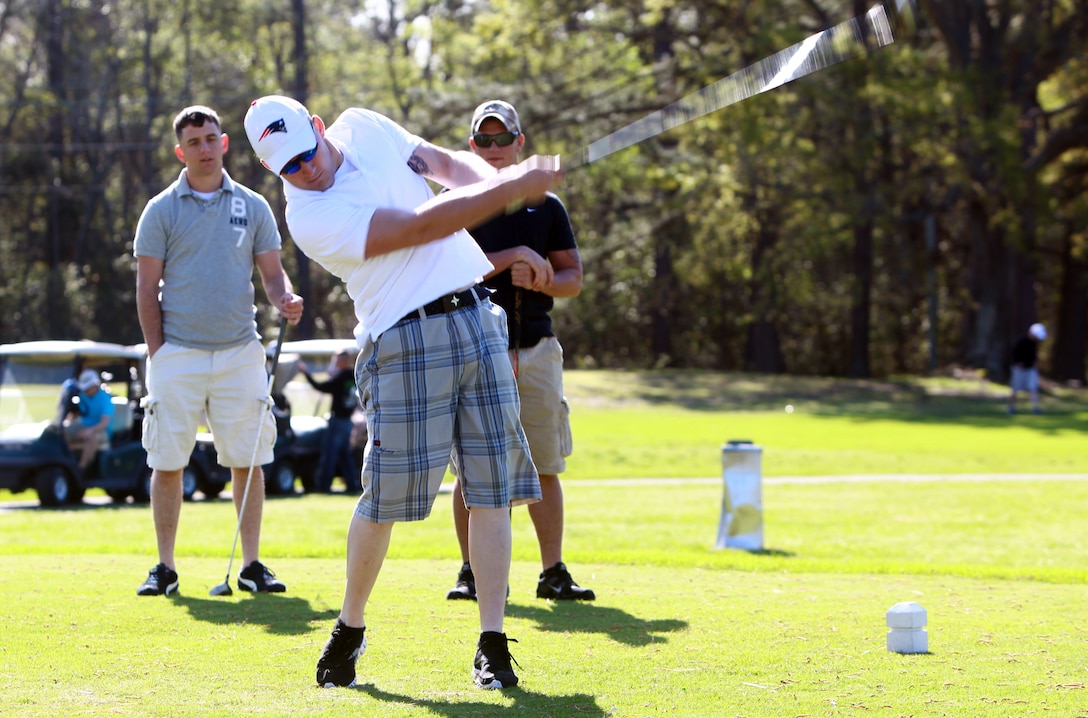 A Marine with Combat Logistics Battalion 8, 2nd Marine Logistics Group hits a golf ball during a golf outing at the Paradise Point Golf Course aboard Camp Lejeune, N.C., March 27, 2012. The purpose of the day was to give the battalion’s Marines and sailors a day of rest and relaxation. (U.S. Marine Corps photo by Pfc. Franklin E. Mercado)