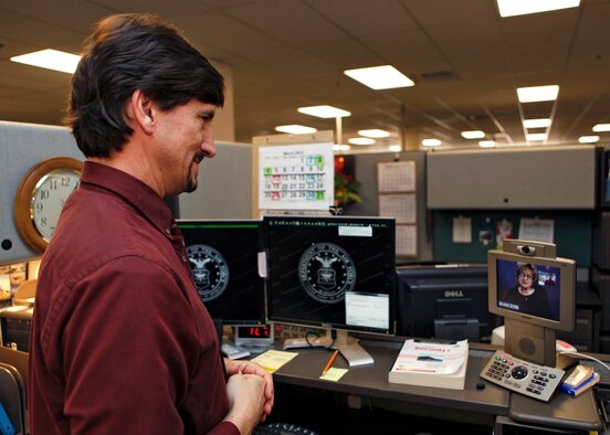 Mike Botte, 95th Communications Squadron Information Technology professional, initiates a call March 23, 2012, via the new video communication device. The new video communication devices will enable deaf and hard-of-hearing employees to make calls via a monitor on their phone connected to a relay interpreter. (U.S. Air Force photo by Jet Fabara)  