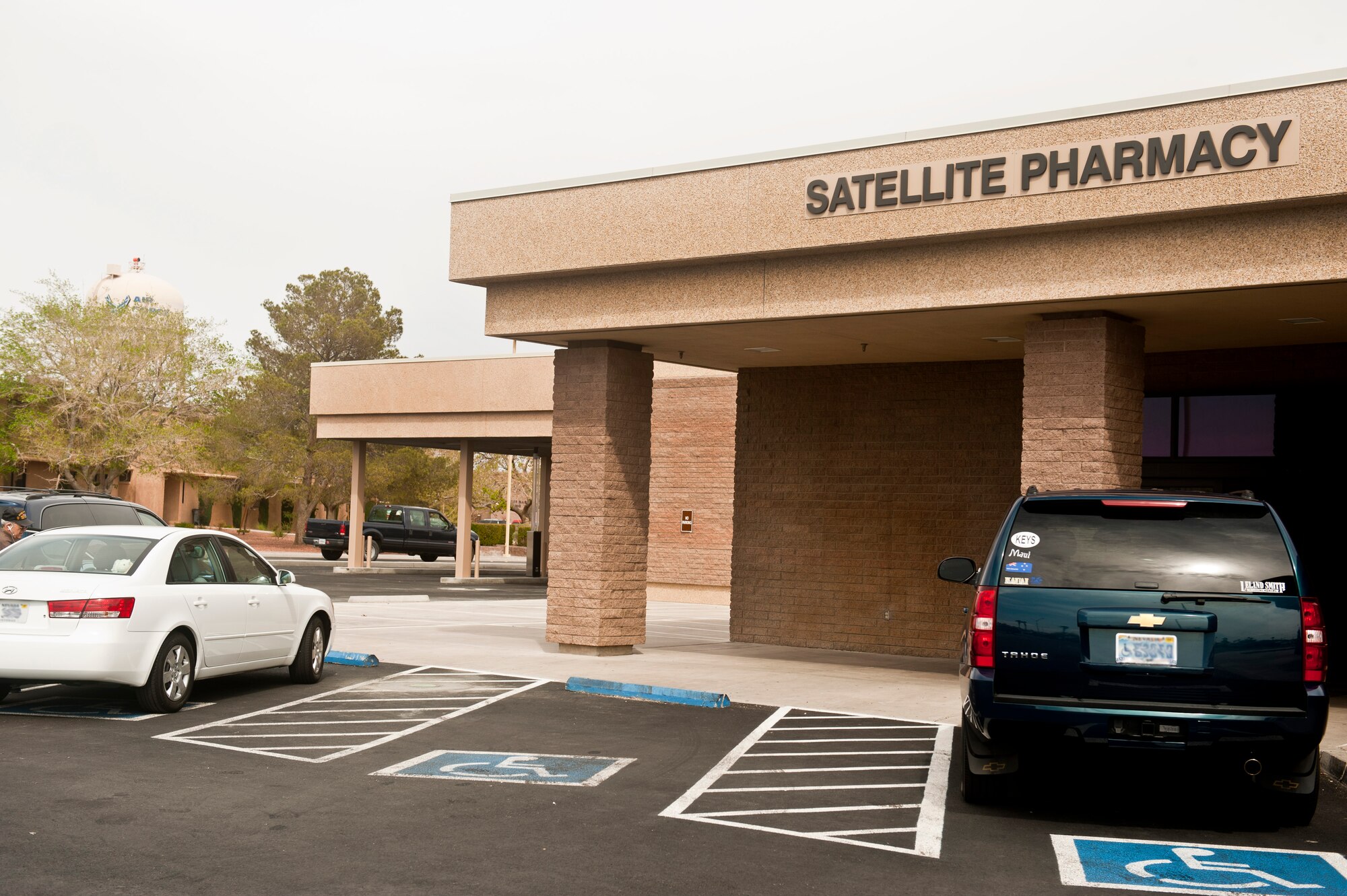 The satellite pharmacy reopened Mar. 26, 2012 at Nellis Air Force Base, Nev., allowing patients needing pharmaceutical refills an alternative to the main Mike O'Callaghan Federal Medical Center Pharmacy. Dependents and military retirees filling off-base prescriptions are encouraged to use the satellite pharmacy as their primary location to fill prescriptions on base. The satellite pharmacy is open to patients Monday- Friday from 7 a.m.-5 p.m. Having a second pharmacy choice on base means faster service for patients at both pharmacy locations. The newly reopened satellite pharmacy offers a drive-through option, which was renovated and expanded to two lanes. (U.S. Air Force photo by Senior Airman Jack Sanders)