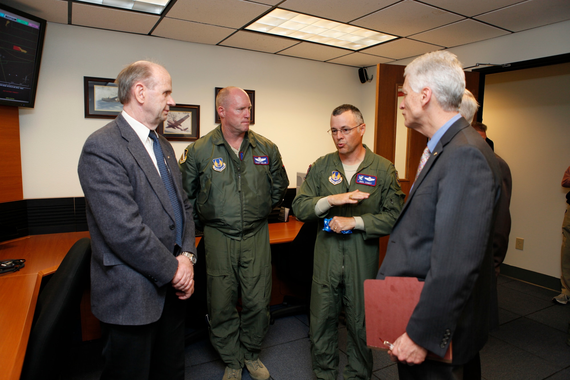 Col. Noel Zamot, United States Air Force Test Pilot School commandant talks with Brig. Gen. Robert C. Nolan II, Air Force Flight Test Center Commander and classmates from Captain Carmen A. Lucci's USAF TPS Class of 80B after the dedication ceremony March 17. Lucci and two other crew members were killed during a test mission March 3, 1981 when their A-26 Invader crashed near Three Sisters Dry Lake, northeast of Edwards. The control room dedication in memory of Lucci helps keep her memory alive and reminds students of the inherent dangers associated with flight test. (Air Force Photo by Jet Fabara)
