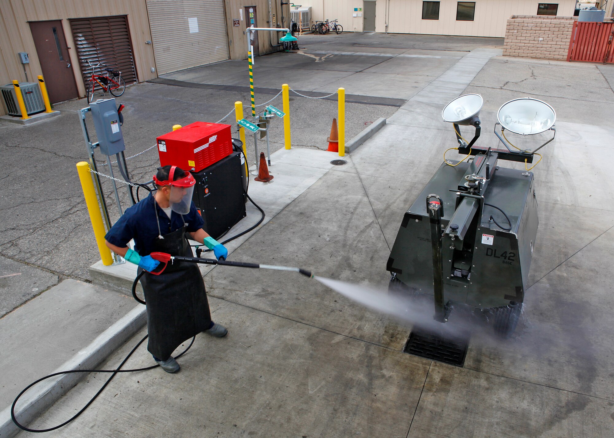 Staff Sgt. Thomas Castro, 412th Maintenance Squadron Aerospace Ground Equipment mechanic, cleans a light cart March 26, 2012, on the new wash rack area which was built as part of an initiative to upgrade two AGE facilities at Edwards. Those in the Aerospace Ground Equipment field are responsible for maintaining the equipment that supplies electricity, as well as hydraulic pressure and air pressure, as planes receive maintenance and prepare for flight. (U.S. Air Force photo by Jet Fabara)