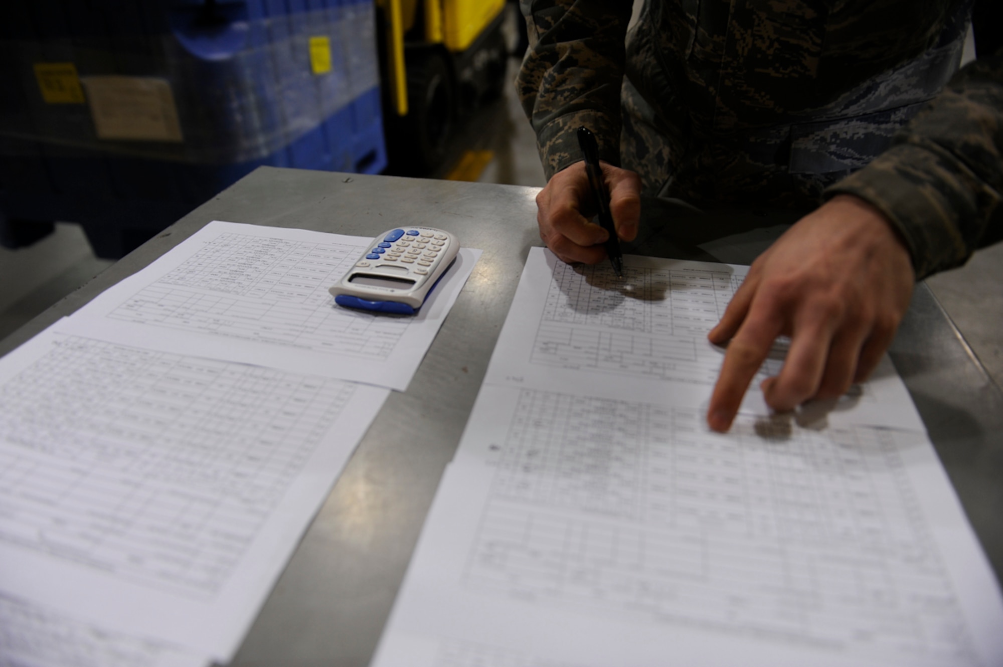 Staff Sgt. Luther Chase, special handling supervisor, verifies the weight of food containers as they are off-loaded from a truck at the 732nd Air Mobilty Squadron warehouse, Joint Base Elmendorf-Richardson, Mar. 15. (U.S. Air Force photo/Tech Sgt. Brian Ferguson)