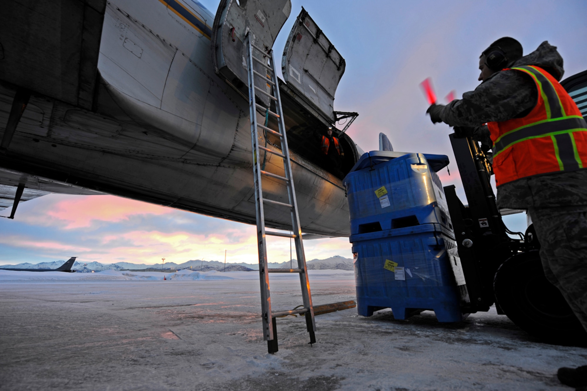 Airmen and civilians from the 732nd Air Mobility Squadron load a DC-6 with sustainment supplies for a long range radar site on the Joint Base Elmendorf-Richardson flightline, Mar. 15. (U.S. Air Force photo/Tech Sgt. Brian Ferguson)