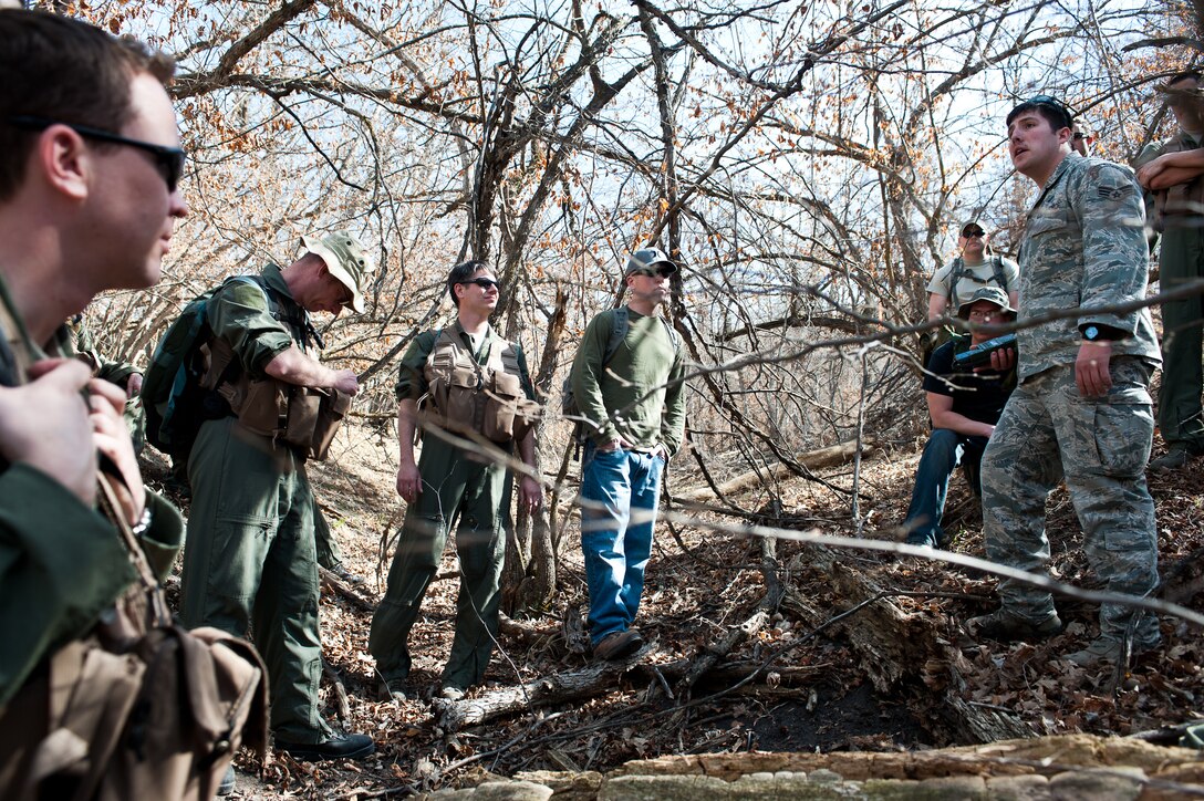 Senior Airman Zachary Yoakam, 28th Operations Support Squadron Survival Evasion Rescue Escape specialist, briefs aircrews during a survival demonstration at the Sturgis Training Compound, Sturgis, S.D., March 22, 2012. This covered techniques for refresher training re-emphasized the importance of applying camouflage to exposed skin, and, finding concealment while awaiting rescue. (U.S. Air Force photo by Airman 1st Class Alystria Maurer/Released)