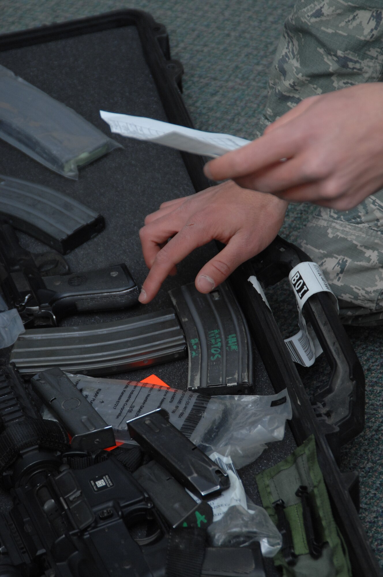 An Airman double checks the contents of a weapon case he checked out from the armory at Mountain Home Air Force Base, Idaho, March 27, 2012. Armory personnel are ultimately responsible for the records, maintenance and cleanliness of all signed out weapons and will safely hold weapon cases for individuals overnight. (U.S. Air Force photo/ Senior Airman Benjamin Sutton) 