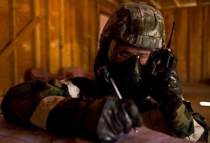 U.S. Air Force Tech. Sgt. Shawn Konen, 99th Civil Engineer Squadron structures craftsman, communicates on a radio during an Operational Readiness Exercise, March 21, 2012, at Nellis Air Force Base, Nev. During an ORE Airmen can be in mission oriented protective posture gear for hours.(U.S. Air Force photo by Airman 1st Class Daniel Hughes)