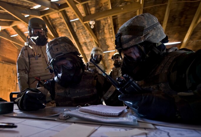 U.S. Air Force Tech. Sgt. Joshua Denniston, and Staff Sgt. Andy Albbe, 99th Security Forces Squadron, report a post-attack reconnaissance sweep conducted during an Operational Readiness Exercise March 21, 2012, at Nellis Air Force Base, Nev. Reporting a PAR sweep correctly to the command post is vital after an enemy attack.(U.S. Air Force photo by Airman 1st Class Daniel Hughes)