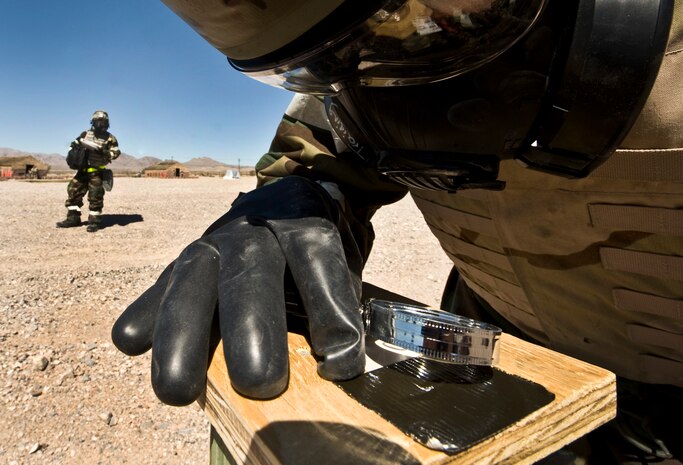 U.S. Air Force Airman 1st Class Mitchell Stoll, 99th Civil Engineer Squadron electrician apprentice, checks M-9 paper for chemical residue during an Operational Readiness Exercise March 21, 2012, at Nellis Air Force Base, Nev. M-9 paper is used to detect chemical agents used after an attack.(U.S. Air Force photo by Airman 1st Class Daniel Hughes)
