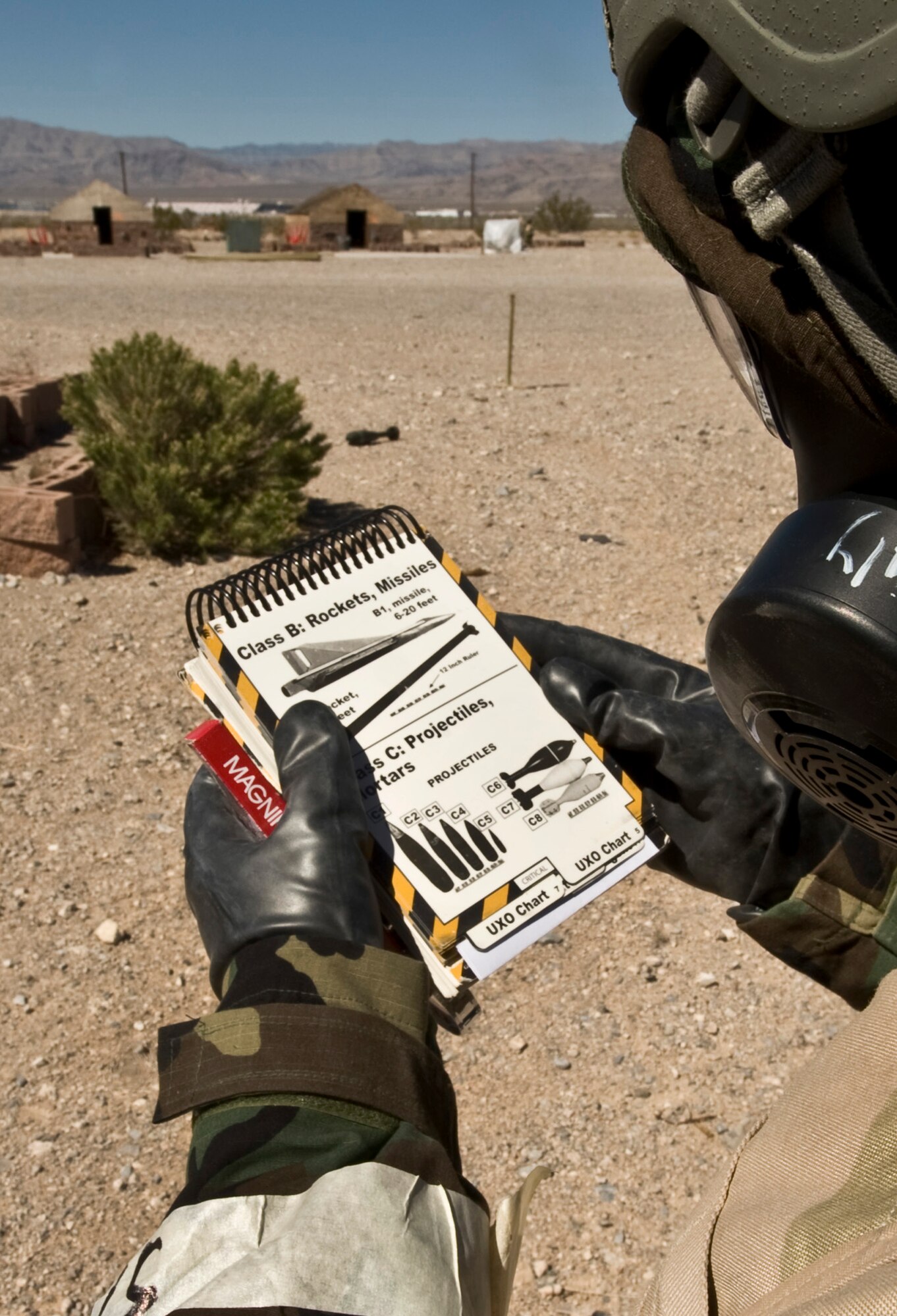U.S. Air Force Airman 1st Class Mitchell Stoll, 99th Civil Engineer Squadron electrician apprentice, checks an Airman's Manual for guidance on identifying a projectile during an Operational Readiness Exercise March 21, 2012, at Nellis Air Force Base, Nev. The Airman's Manual provides a quick reference of essential combat and survival skills. (U.S. Air Force photo by Airman 1st Class Daniel Hughes)
