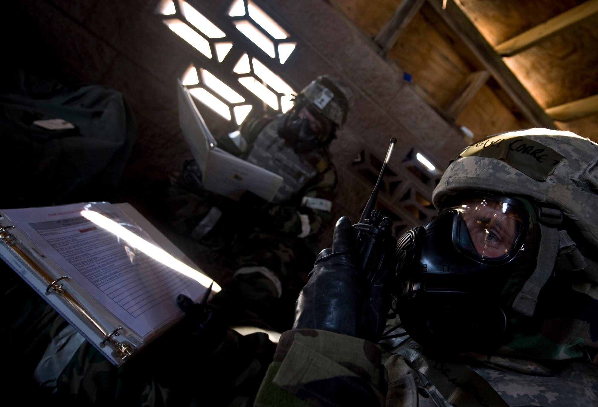 U.S. Air Force Tech. Sgt. Joshua Denniston, 99th Security Forces Squadron, reports in to the command post during an Operational Readiness Exercise, March 21, 2012, at Nellis Air Force Base, Nev. The Ability to Survive and Operate training portion of the ORE tested Airmen on base defense tactics and the ability to communicate under a stressful environment. (U.S. Air Force photo by Airman 1st Class Daniel Hughes)
