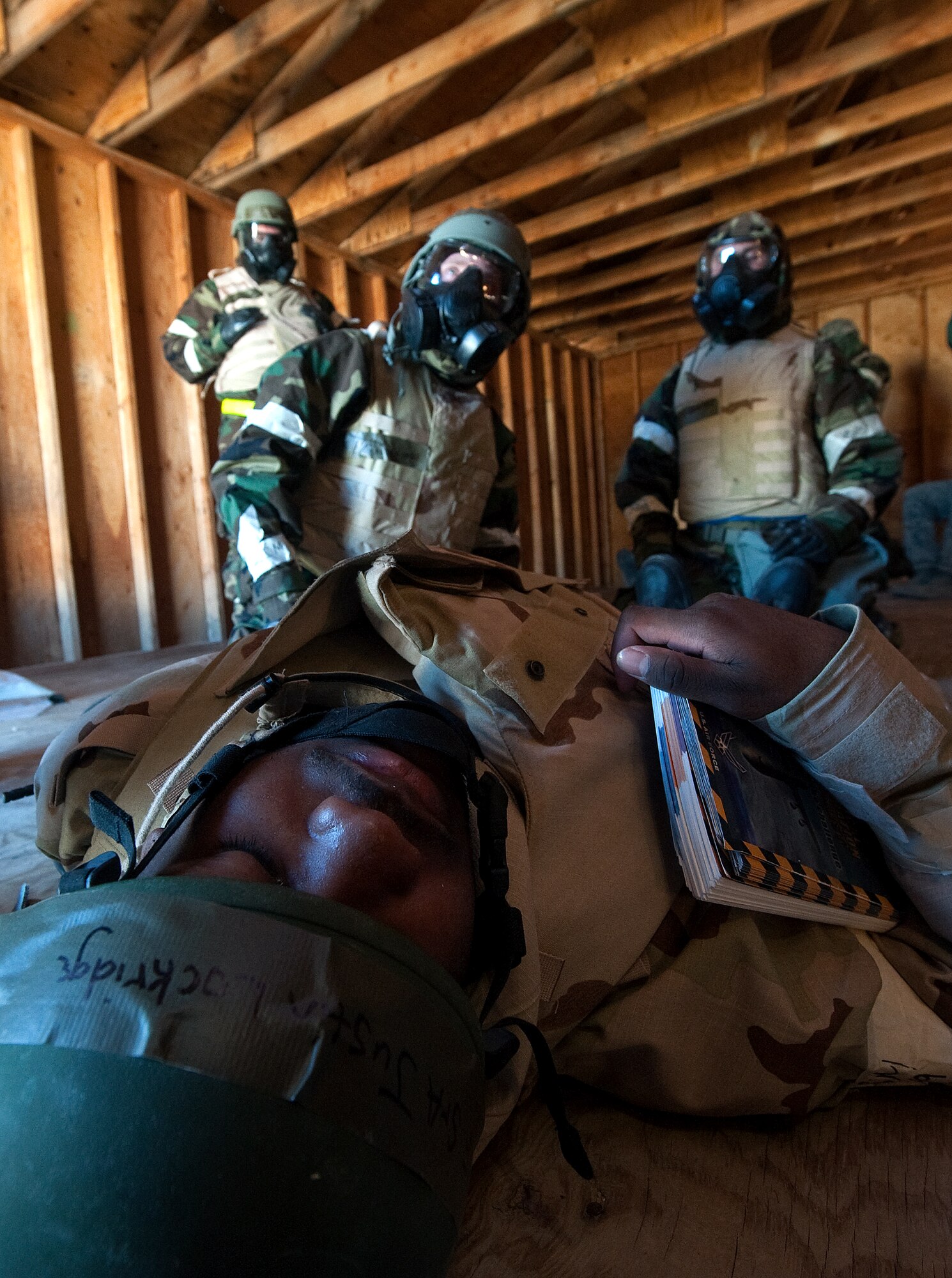 U.S. Air Force Senior Airman Justin Lockridge, 99th Civil Engineer Squadron operations management apprentice, simulates being a casualty so Airmen can practice self aid and buddy care techniques during an Operational Readiness Exercise March 21, 2012 at Nellis Air Force Base, Nev. The ORE tested Airmen on how to successfully execute a quick deployment tasking while continuing with daily operations. (U.S. Air Force photo by Staff Sgt. Christopher Hubenthal)