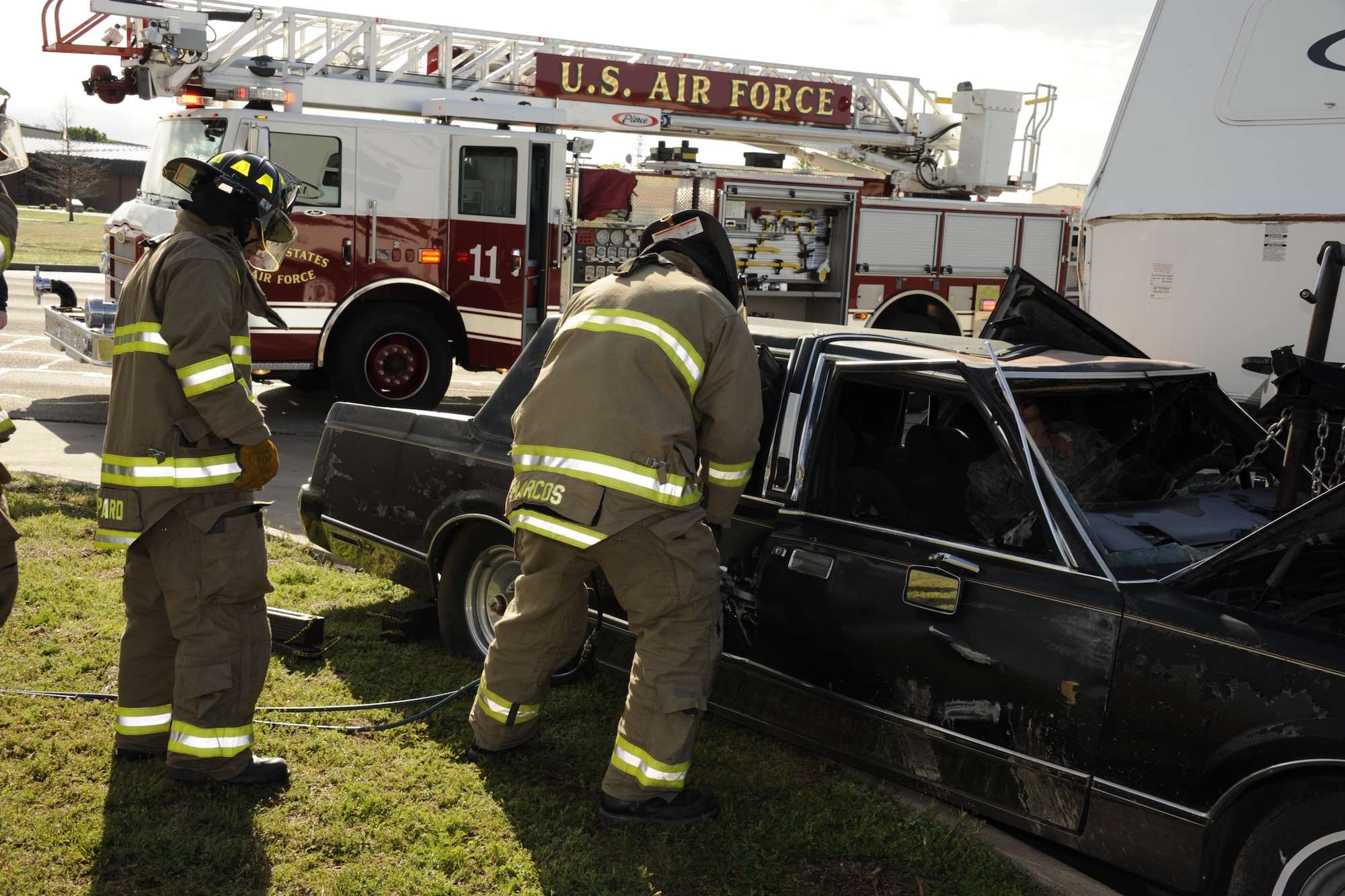 Sheppard firefighters work to open the door of a damaged vehicle during a base Severe Weather Response Exercise March 21. Through practice and education provided by the base Emergency Management Office, Sheppard personnel can be prepared for tornado season. (U.S. Air Force photo/Danny Webb)