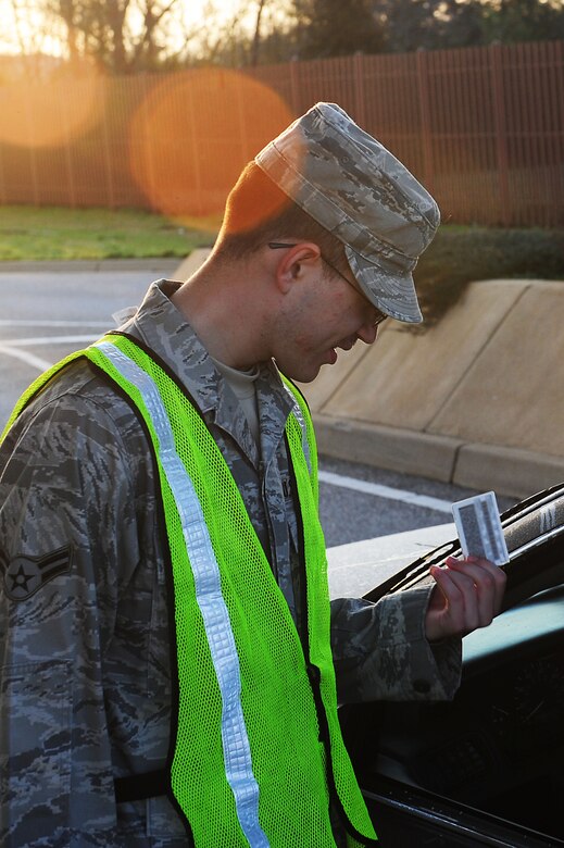 U.S. Air Force Airman 1st Class Gregory Koenig, 94th Aircraft Maintenance Unit, checks an identification card at Langley Air Force Base, Va., March 14, 2012.  The 633rd Security Forces Squadron trains augmentee gatekeepers to protect the base from unauthorized personnel by using proper entry-control procedures.  (U.S. Air Force photo by Airman 1st Class Kayla Newman/Released)