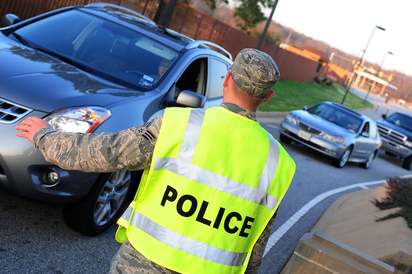 U.S. Air Force Senior Airman Chris Kernan, 440th Supply Chain Operations Squadron, stops traffic 
to check an identification card at Langley Air Force Base, Va., March 14, 2012.    As part of the 633rd 
Security Forces Squadron Augmentee Program, individuals work as entry controllers granting people 
access onto the base.  (U.S. Air Force photo by Airman 1st Class Kayla Newman/Released)
